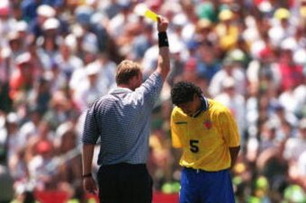 26 Jun 1994: HERMAN GAVIRIA IS GIVEN A YELLOW CARD BY THE REFEREE DURING THE 1994 WORLD CUP MATCH BETWEEN COLOMBIA V SWITZERLAND AT THE STANFORD STADIUM IN PALO ALTO, CALIFORNIA. ALSO PICTURED AT RIGHT IS ALEXIS MENDOZA #3 OF COLOMBIA AND ADRIAN KNUP #9 O