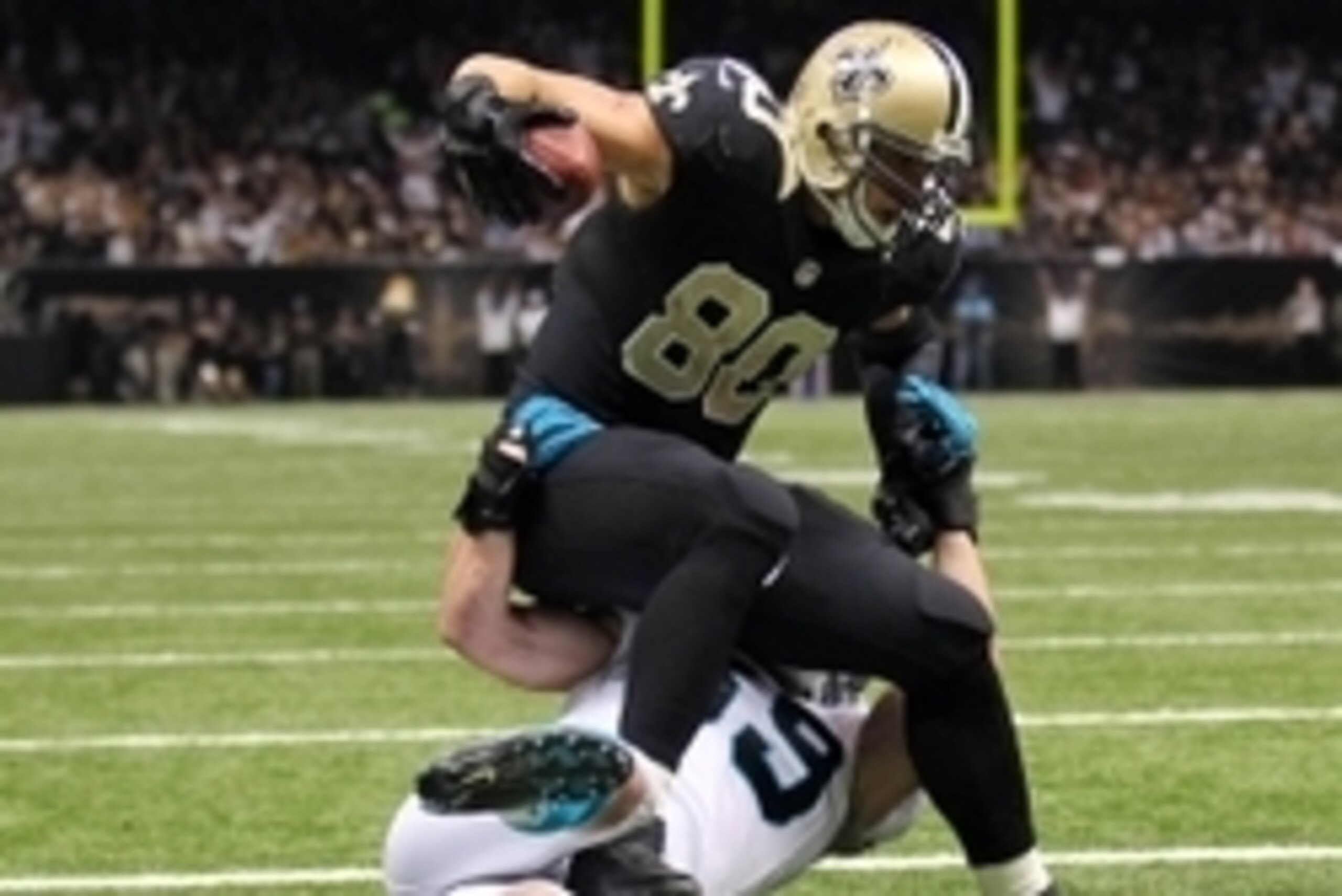 Dec 8, 2013; New Orleans, LA, USA; New Orleans Saints tight end Jimmy Graham (80) is tackled by Carolina Panthers middle linebacker Luke Kuechly (59) as he carries the ball into the end zone for a touchdown in the second quarter at Mercedes-Benz Superdome