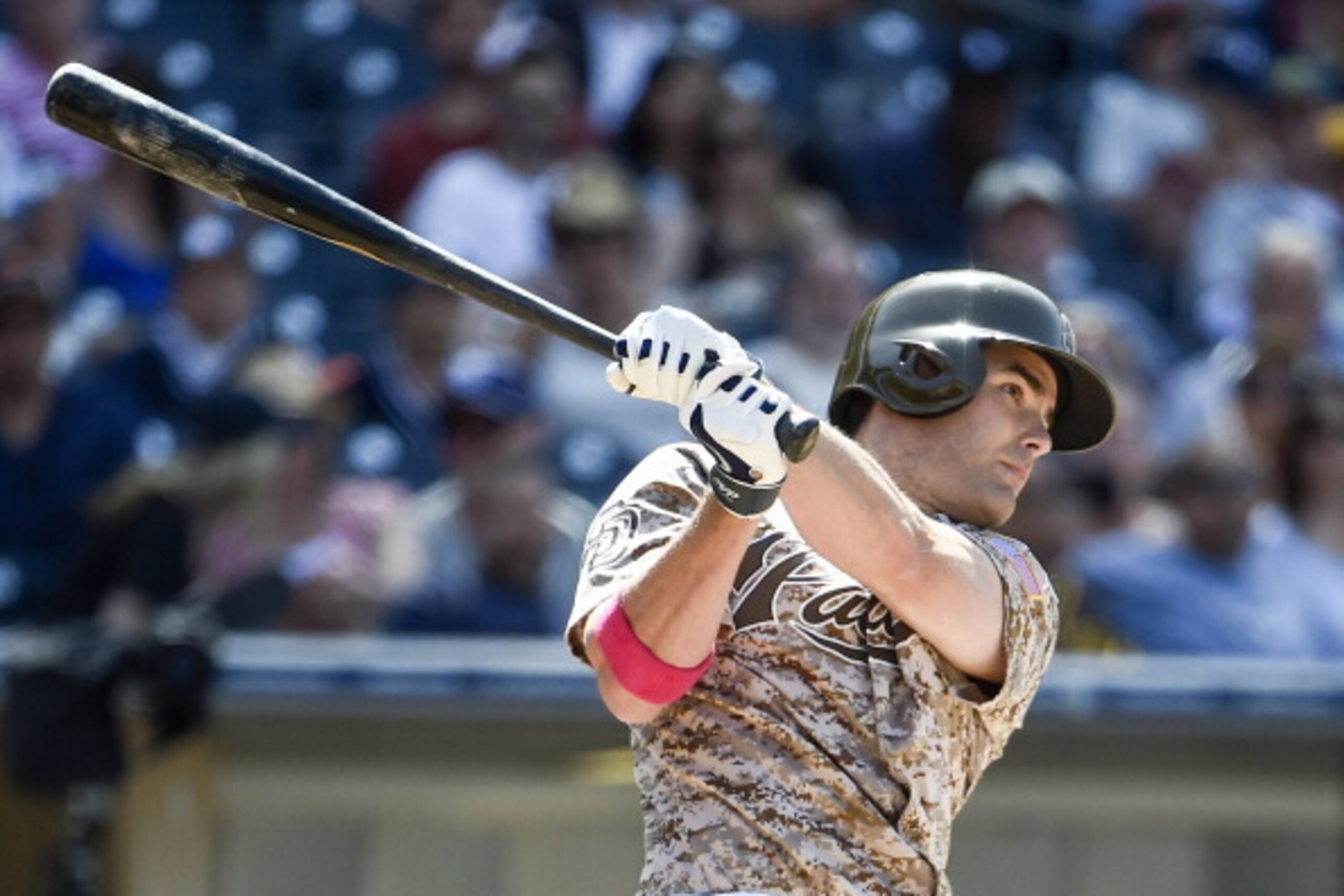 SAN DIEGO, CA - MAY 11:  Seth Smith #12 of the San Diego Padres hits a double during the sixth inning of a baseball game against the Miami Marlins at Petco Park May 11, 2014 in San Diego, California.  (Photo by Denis Poroy/Getty Images)