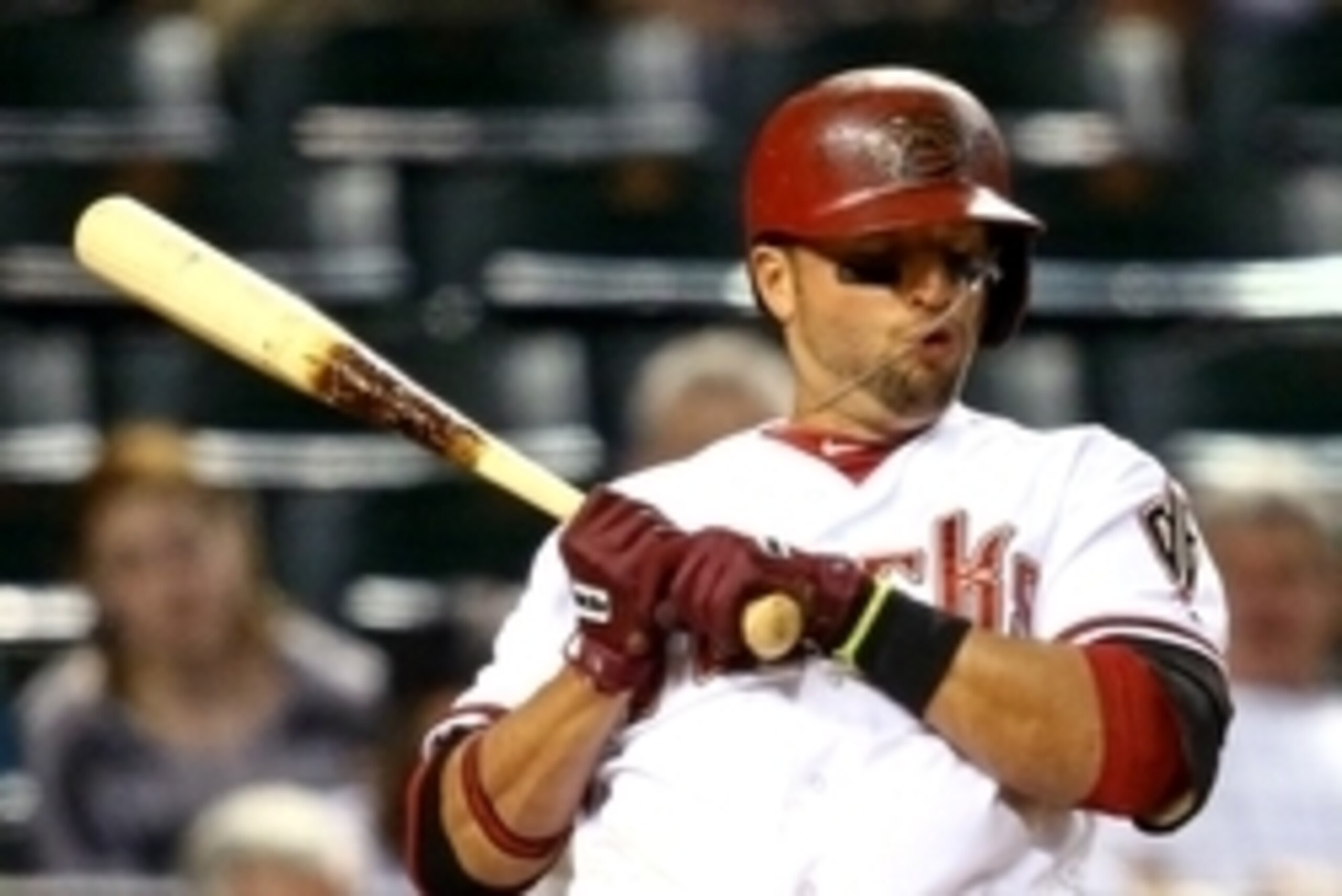May 13, 2014; Phoenix, AZ, USA; Arizona Diamondbacks third baseman Martin Prado reacts as his cross necklace hits him in the face against the Washington Nationals at Chase Field. Mandatory Credit: Mark J. Rebilas-USA TODAY Sports