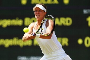 LONDON, ENGLAND - JULY 02:  Eugenie Bouchard of Canada during her Ladies' Singles quarter-final match against Angelique Kerber of Germany on day nine of the Wimbledon Lawn Tennis Championships at the All England Lawn Tennis and Croquet Club  at Wimbledon 