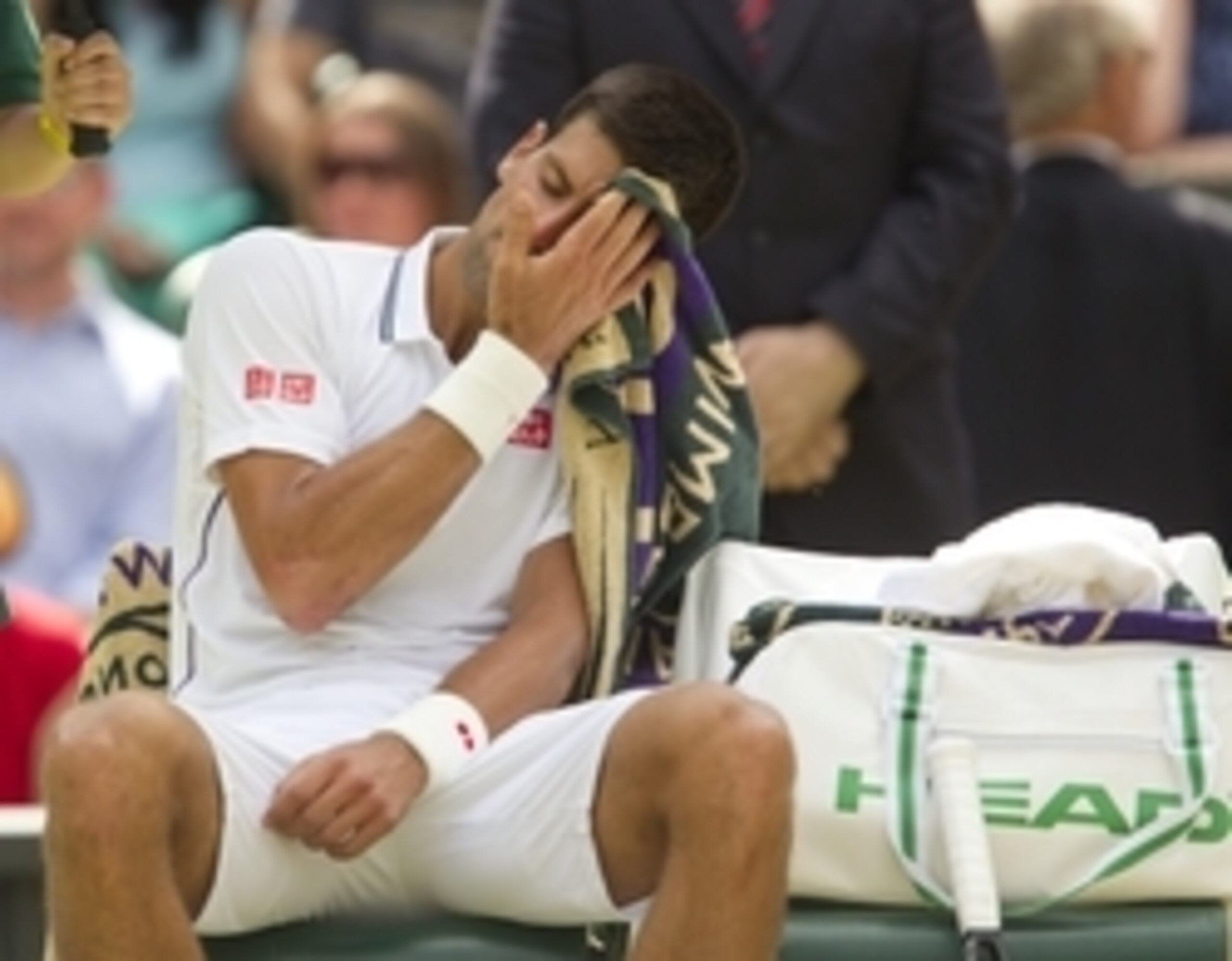 Jun 27, 2014;2014; London, United Kingdom; Novak Djokovic (SRB) waits to receive treatment after slipping and falling during his match against Gilles Simon (FRA) on day five of the 2014 Wimbledon Championships at the All England Lawn and Tennis Club. Mand Jun 27, 2014;2014; London, United Kingdom; Novak Djokovic (SRB) waits to receive treatment after slipping and falling during his match against Gilles Simon (FRA) on day five of the 2014 Wimbledon Championships at the All England Lawn and Tennis Club. Mand