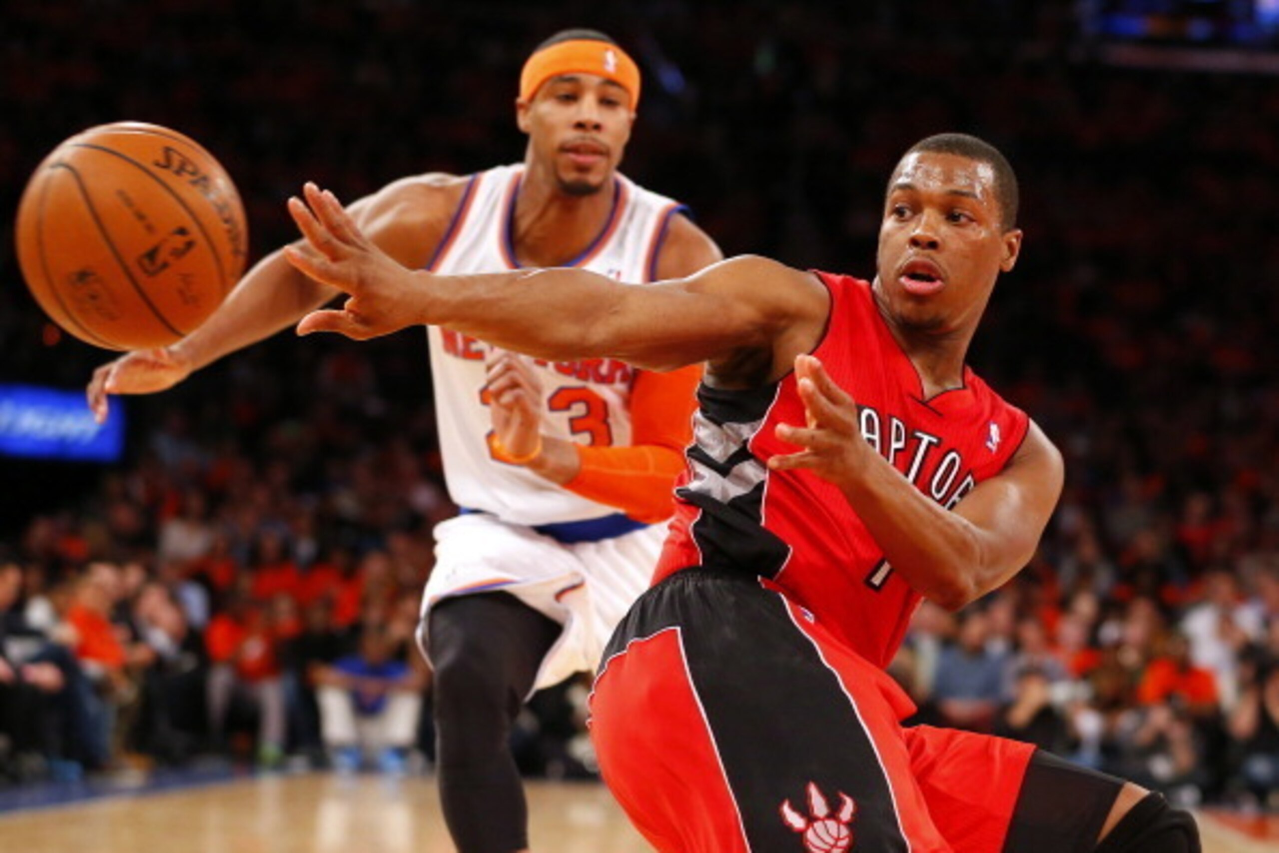 NEW YORK, NY - APRIL 16: Kyle Lowry #7 of the Toronto Raptors passes the ball as Toure Murry #23 of the New York Knicks defends in the first half during an NBA basketball game at Madison Square Garden on April. 16, 2014 in New York City. The Knicks defeat