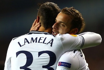 LONDON, ENGLAND - DECEMBER 12:  Roberto Soldado of Tottenham Hotspur hugs Erik Lamela of Tottenham Hotspur after scoring the first goal during the UEFA Europa League Group K match between Tottenham Hotspur FC and FC Anji Makhachkala at White Hart Lane on