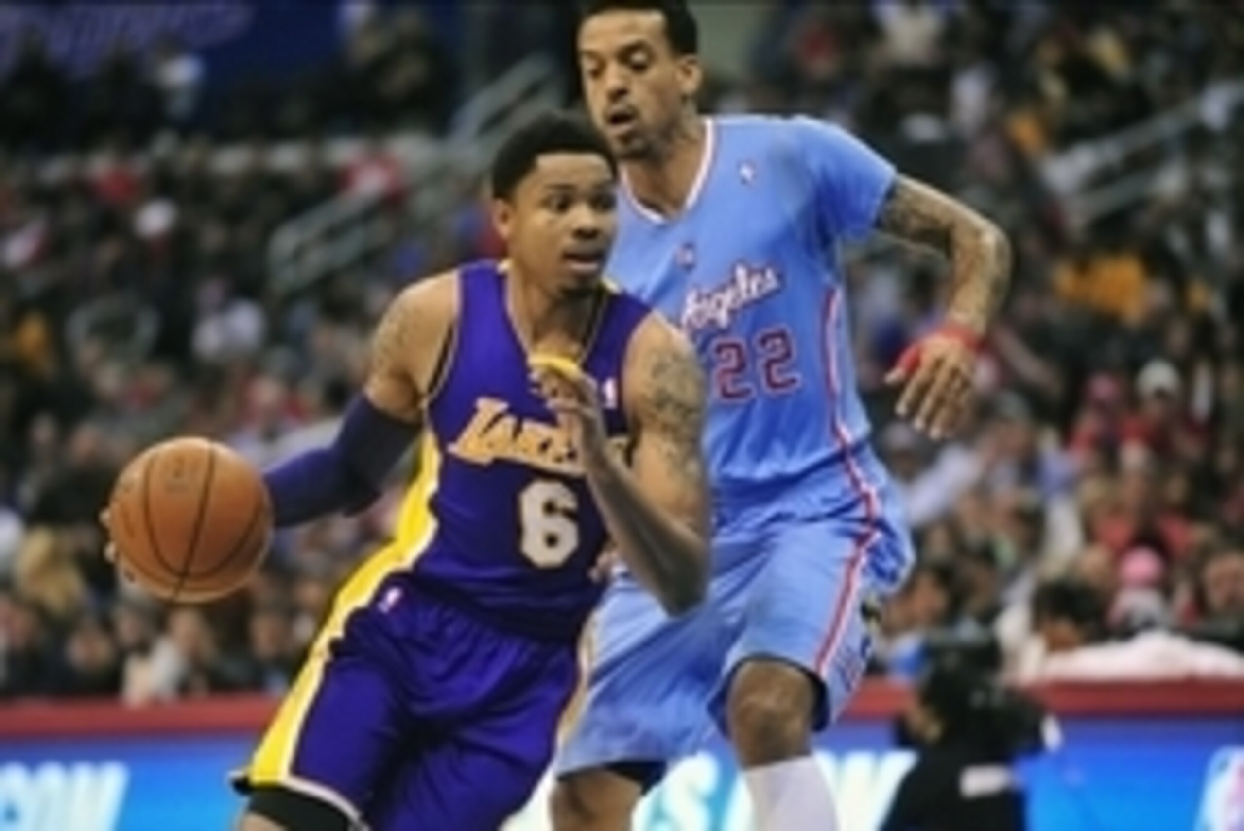 April 6, 2014; Los Angeles, CA, USA; Los Angeles Lakers guard Kent Bazemore (6) moves the ball against Los Angeles Clippers forward Matt Barnes (22) during the first half at Staples Center. Mandatory Credit: Gary A. Vasquez-USA TODAY Sports