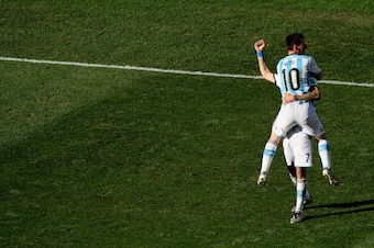 SAO PAULO, BRAZIL - JULY 01:  Lionel Messi of Argentina celebrates the winning goal with Angel Di Maria who scored it during the 2014 FIFA World Cup Brazil Round of 16 match between Argentina and Switzerland at Arena de Sao Paulo on July 1, 2014 in Sao Pa