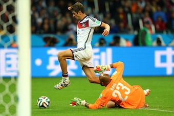 PORTO ALEGRE, BRAZIL - JUNE 30: Thomas Mueller of Germany attempts a shot against Rais M'Bolhi of Algeria during the 2014 FIFA World Cup Brazil Round of 16 match between Germany and Algeria at Estadio Beira-Rio on June 30, 2014 in Porto Alegre, Brazil.  (