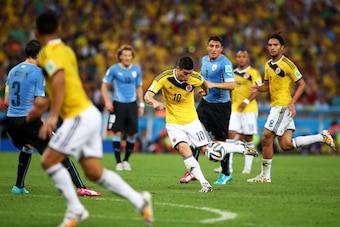 RIO DE JANEIRO, BRAZIL - JUNE 28:  James Rodriguez of Colombia shoots and scoores his team's first goal during the 2014 FIFA World Cup Brazil round of 16 match between Colombia and Uruguay at Maracana on June 28, 2014 in Rio de Janeiro, Brazil.  (Photo by