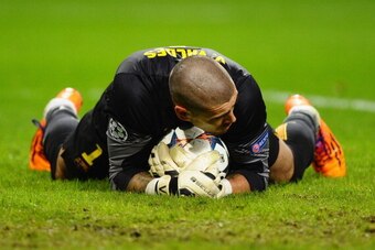 MANCHESTER, ENGLAND - FEBRUARY 18:   Victor Valdes of Barcelona makes a save during the UEFA Champions League Round of 16 first leg match between Manchester City and Barcelona at the Etihad Stadium on February 18, 2014 in Manchester, England.  (Photo by L