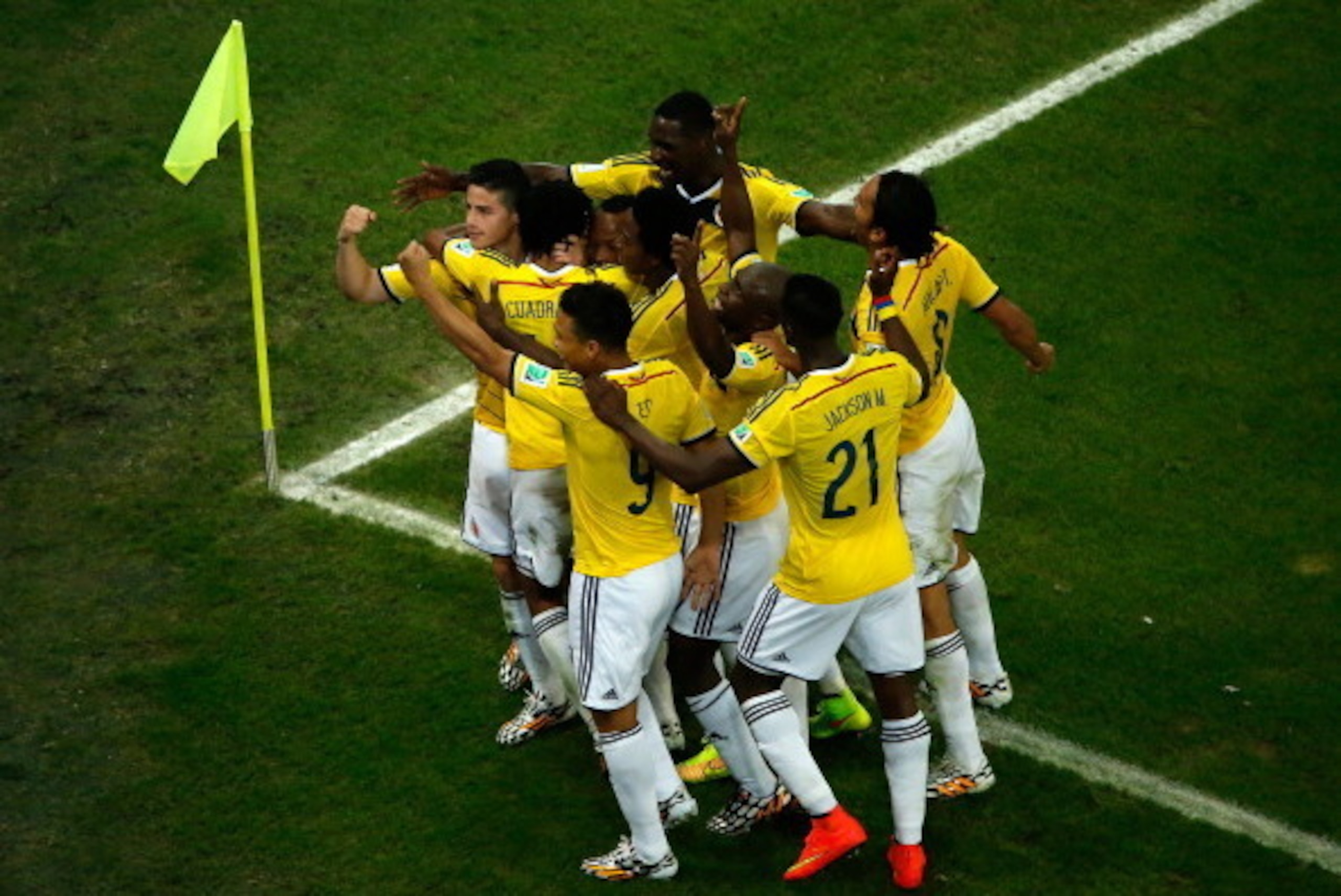 RIO DE JANEIRO, BRAZIL - JUNE 28:  James Rodriguez of Colombia celebrates scoring his team's second goal and his second of the game with teammates during the 2014 FIFA World Cup Brazil round of 16 match between Colombia and Uruguay at Maracana on June 28,