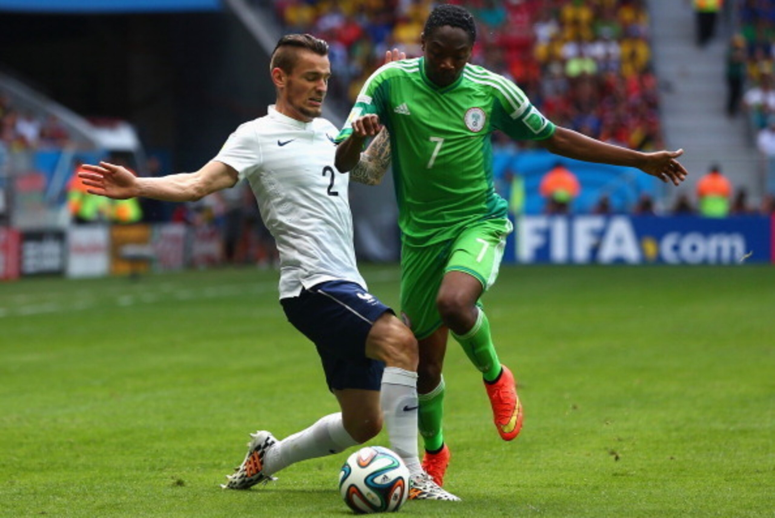 BRASILIA, BRAZIL - JUNE 30: Mathieu Debuchy of France challenges Ahmed Musa of Nigeria during the 2014 FIFA World Cup Brazil Round of 16 match between France and Nigeria at Estadio Nacional on June 30, 2014 in Brasilia, Brazil.  (Photo by Quinn Rooney/Get