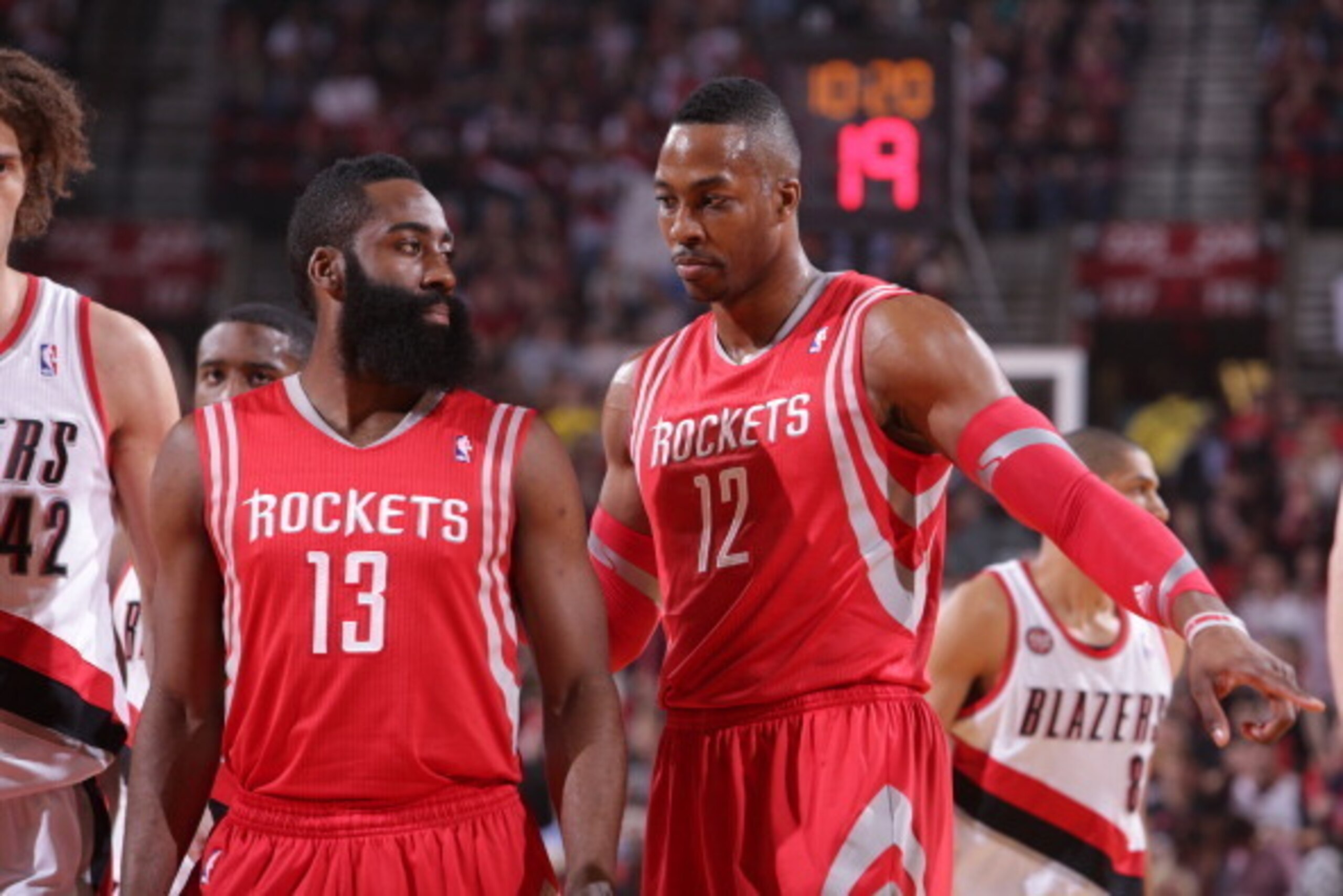 PORTLAND, OR - MAY 2:  James Harden #13 and Dwight Howard #12 of the Houston Rockets walk up court in Game Six of the Western Conference Quarterfinals against the Portland Trail Blazers during the 2014 NBA Playoffs on May 2, 2014 at the Moda Center in Por