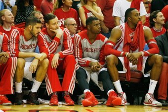 HOUSTON, TX - APRIL 23:  (L-R) Omri Casspi #18, Donatas Motiejunas #20, Terrence Jones #6 and Dwight Howard #12 of the Houston Rockets sit on the bench against the Portland Trail Blazers during the second half of Game Two of the Western Conference Quarter