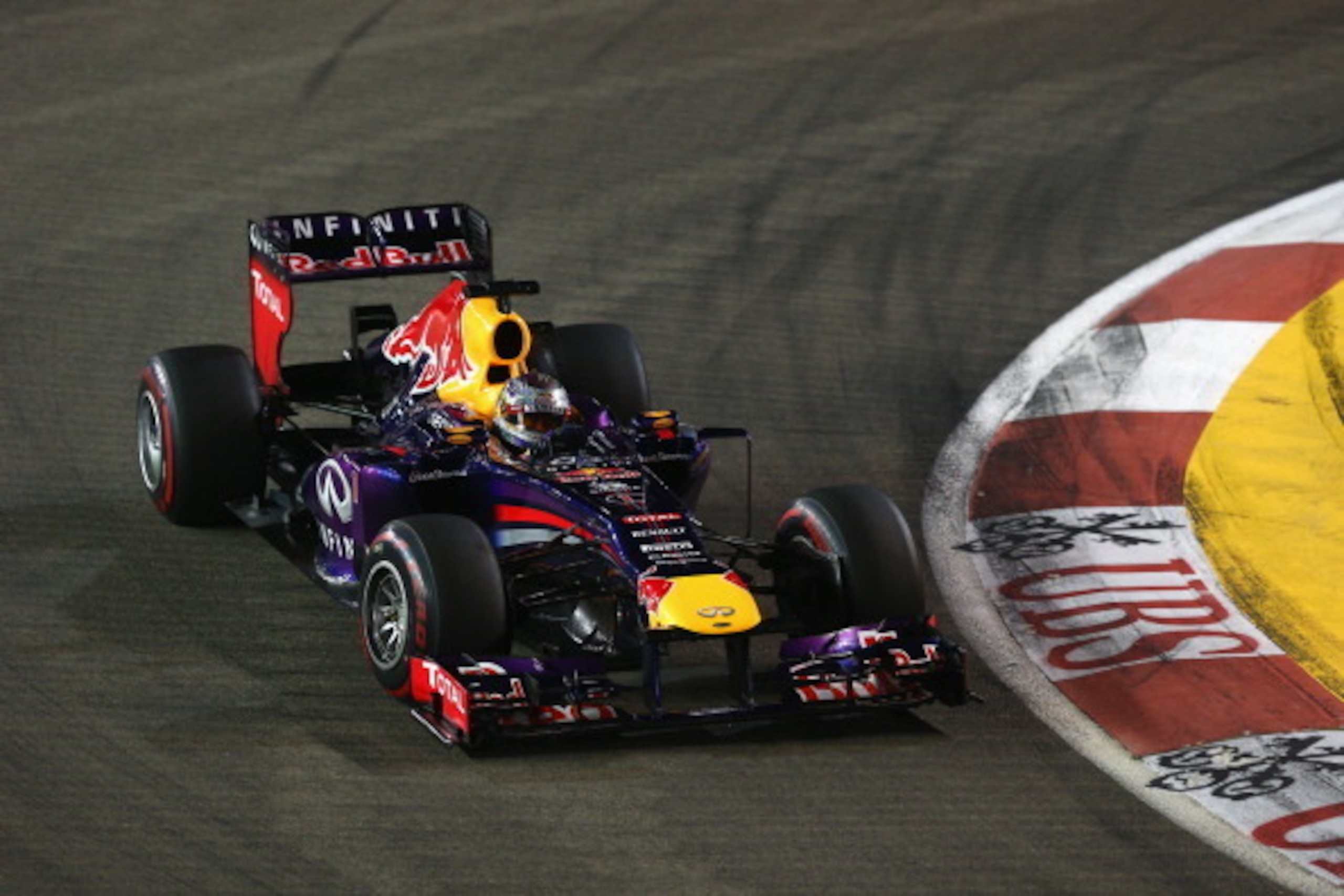 SINGAPORE - SEPTEMBER 22:  Sebastian Vettel of Germany and Infiniti Red Bull racing drives during the Singapore Formula One Grand Prix at Marina Bay Street Circuit on September 22, 2013 in Singapore, Singapore.  (Photo by Paul Gilham/Getty Images)