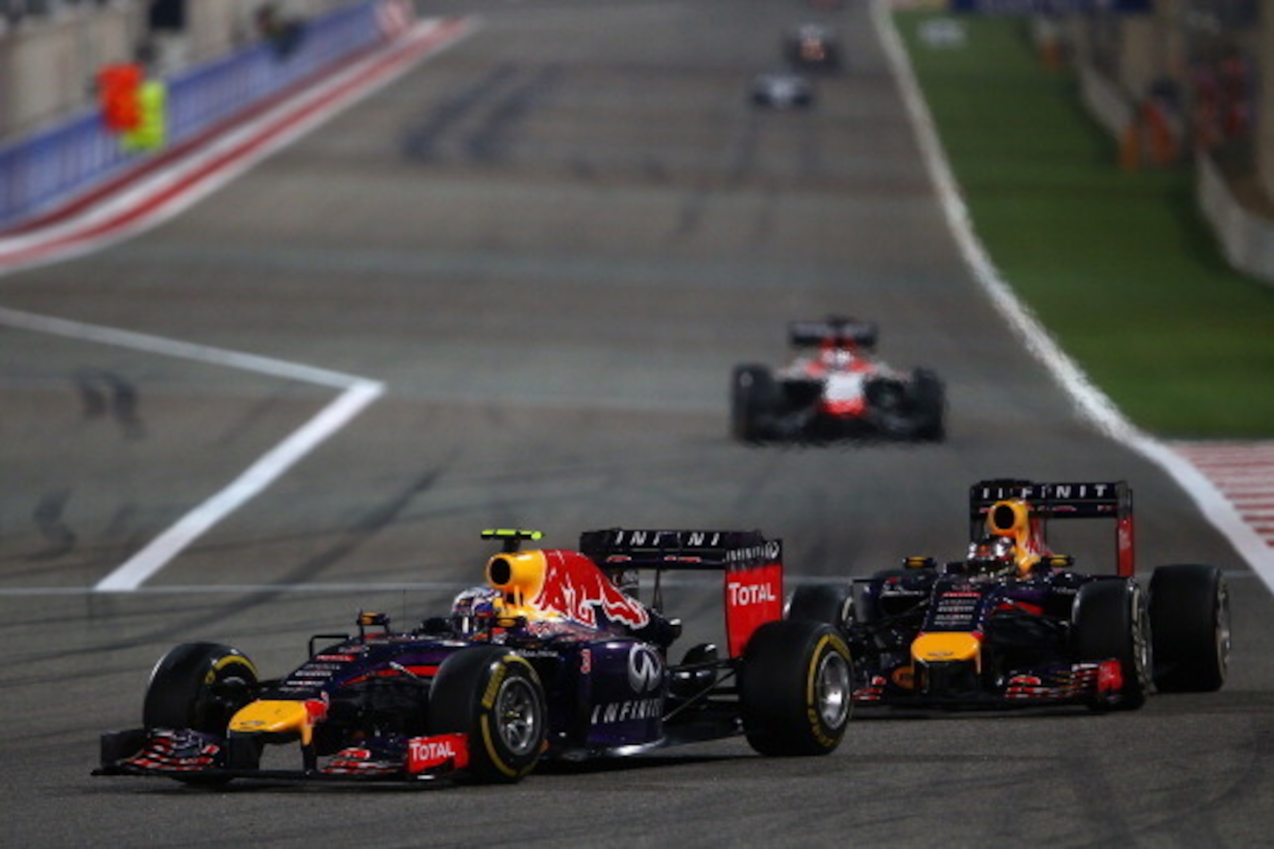SAKHIR, BAHRAIN - APRIL 06:  Daniel Ricciardo of Australia and Infiniti Red Bull Racing leads from Sebastian Vettel of Germany and Infiniti Red Bull Racing during the Bahrain Formula One Grand Prix at the Bahrain International Circuit on April 6, 2014 in 