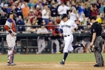 Jun 25, 2014; Seattle, WA, USA; Seattle Mariners shortstop Brad Miller (5) crosses home plate after hitting a solo home run against the Boston Red Sox during the eighth inning at Safeco Field. Mandatory Credit: Steven Bisig-USA TODAY Sports