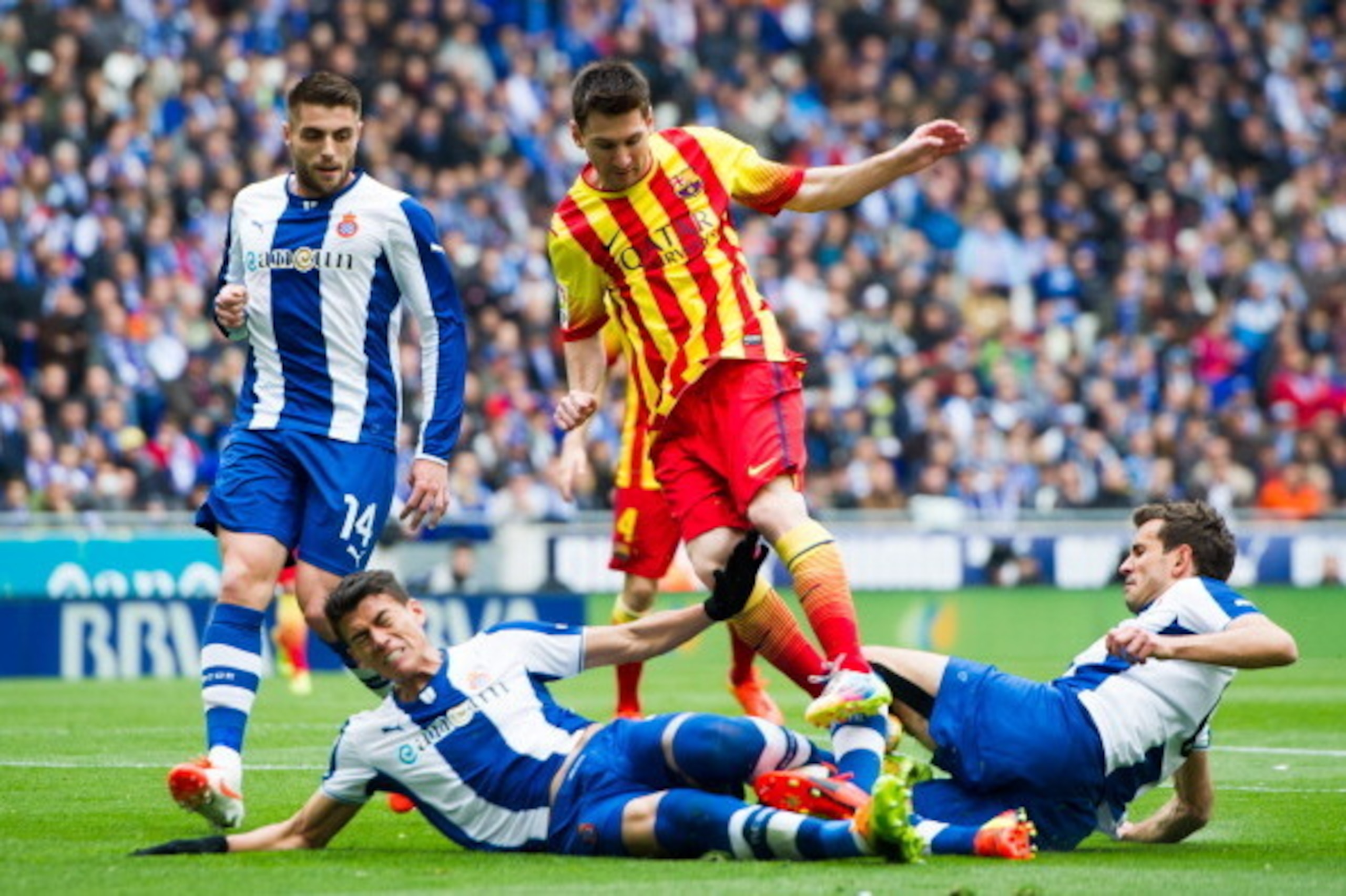 BARCELONA, SPAIN - MARCH 29: Hector Moreno (2nd, L) and Cristhian Stuani (R) of RCD Espanyol fight for the ball with Lionel Messi (C) of FC Barcelona during the La Liga match between RCD Espanyol and FC Barcelona at Cornella-El Prat Stadium on March 29, 2