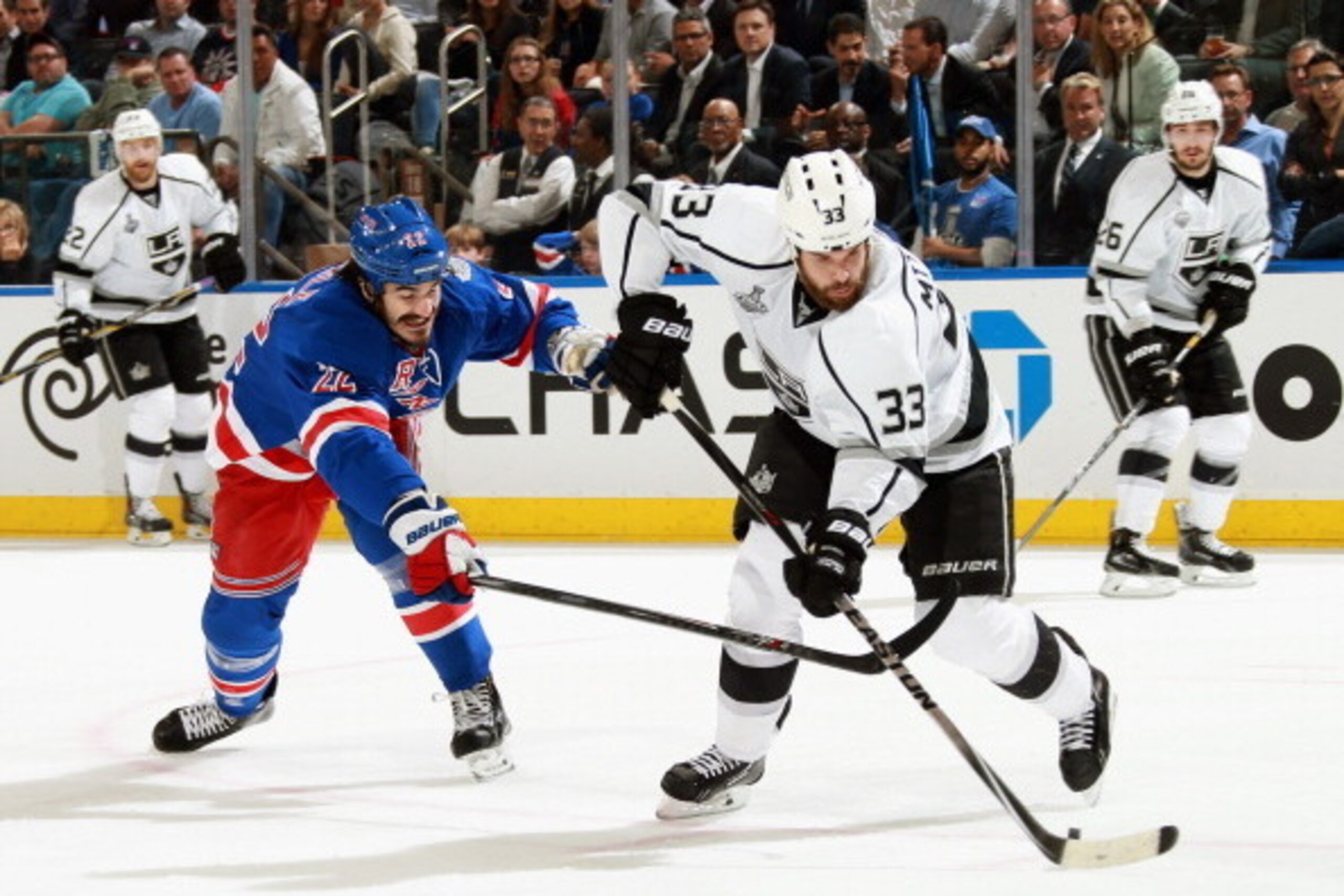 NEW YORK, NY - JUNE 11:  Brian Boyle #22 of the New York Rangers tries to stop Willie Mitchell #33 of the Los Angeles Kings in the first period of Game Four of the 2014 Stanley Cup Final at Madison Square Garden on June 11, 2014 in New York City.  (Photo 