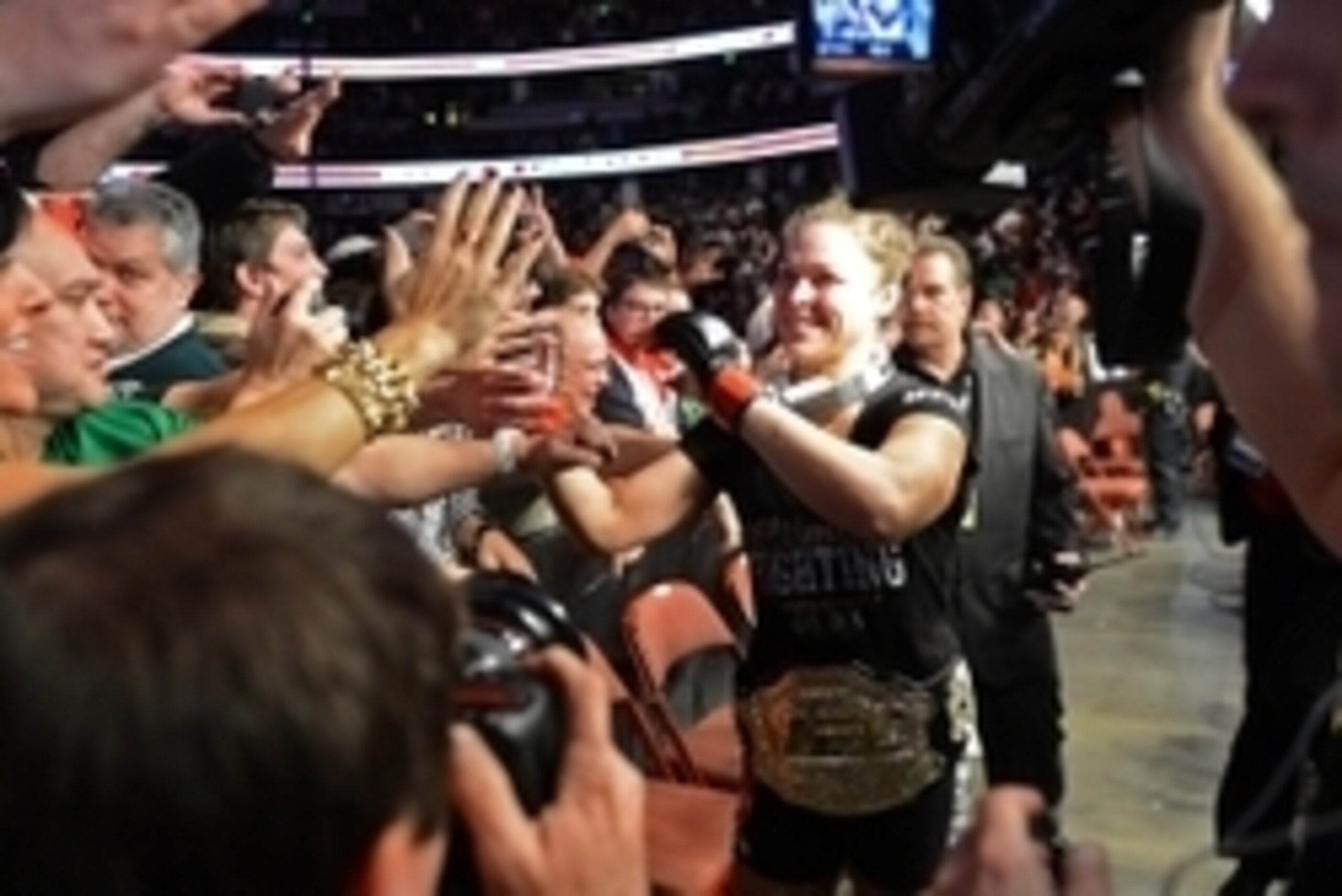 Feb 23, 2013; Anaheim, CA, USA;    Ronda Rousey celebrates with fans after her fight with Liz Carmouche (not pictured) in their UFC women's world bantamweight championship bout at the Honda Center. Mandatory Credit: Jayne Kamin-Oncea-USA TODAY Sports