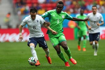 BRASILIA, BRAZIL - JUNE 30: Mathieu Valbuena of France is challenged by Emmanuel Emenike of Nigeria during the 2014 FIFA World Cup Brazil Round of 16 match between France and Nigeria at Estadio Nacional on June 30, 2014 in Brasilia, Brazil. (Photo by Jef BRASILIA, BRAZIL - JUNE 30: Mathieu Valbuena of France is challenged by Emmanuel Emenike of Nigeria during the 2014 FIFA World Cup Brazil Round of 16 match between France and Nigeria at Estadio Nacional on June 30, 2014 in Brasilia, Brazil. (Photo by Jef