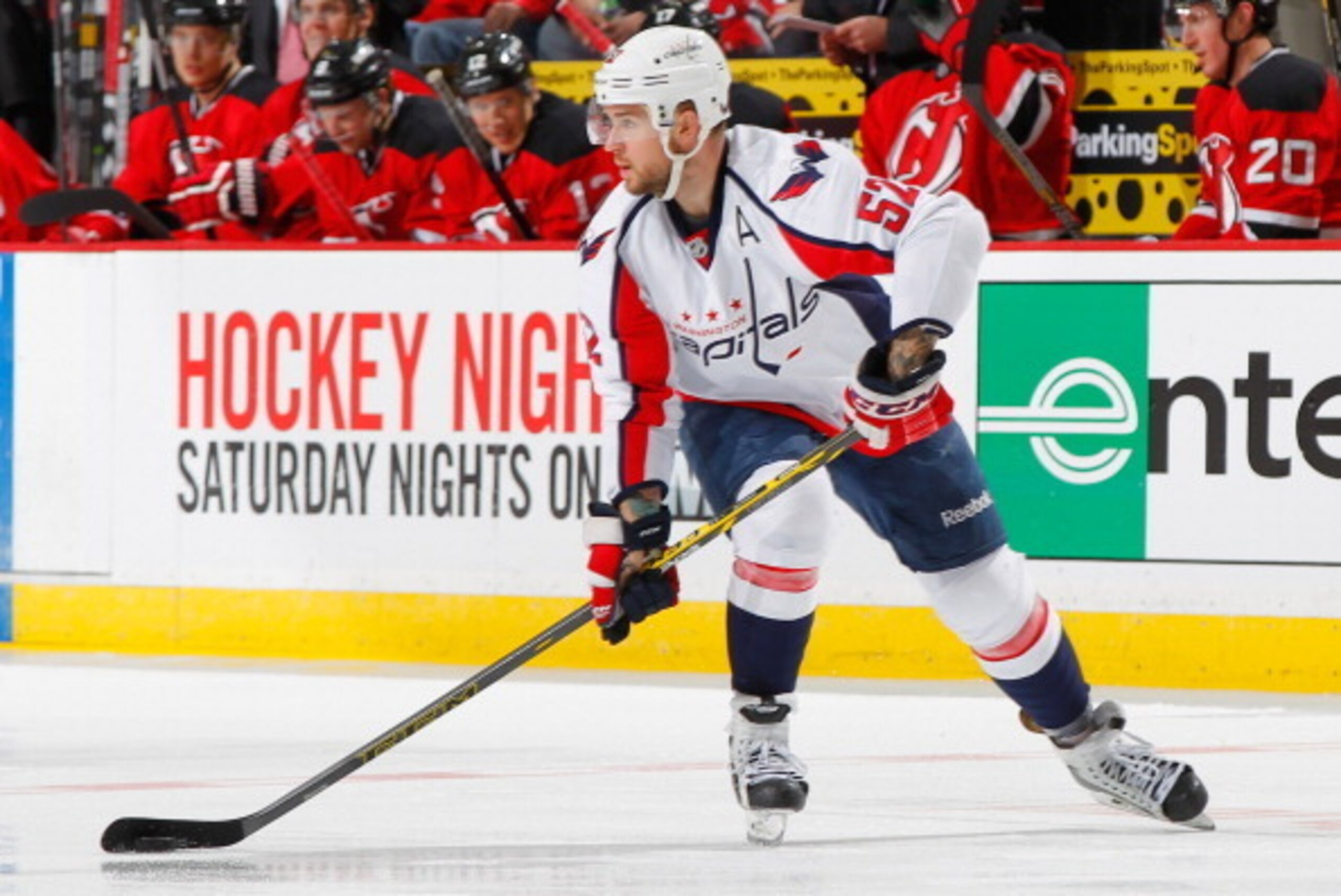 NEWARK, NJ - APRIL 04: Mike Green #52 of the Washington Capitals plays the puck against the New Jersey Devils during the game at the Prudential Center on April 4, 2014 in Newark, New Jersey. (Photo by Andy Marlin/NHLI via Getty Images)