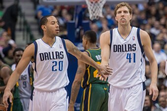 Feb 7, 2014; Dallas, TX, USA; Dallas Mavericks point guard Devin Harris (20) congratulates power forward Dirk Nowitzki (41) during the first half at American Airlines Center. The Mavericks won 103-81. Mandatory Credit: Jerome Miron-USA TODAY Sports