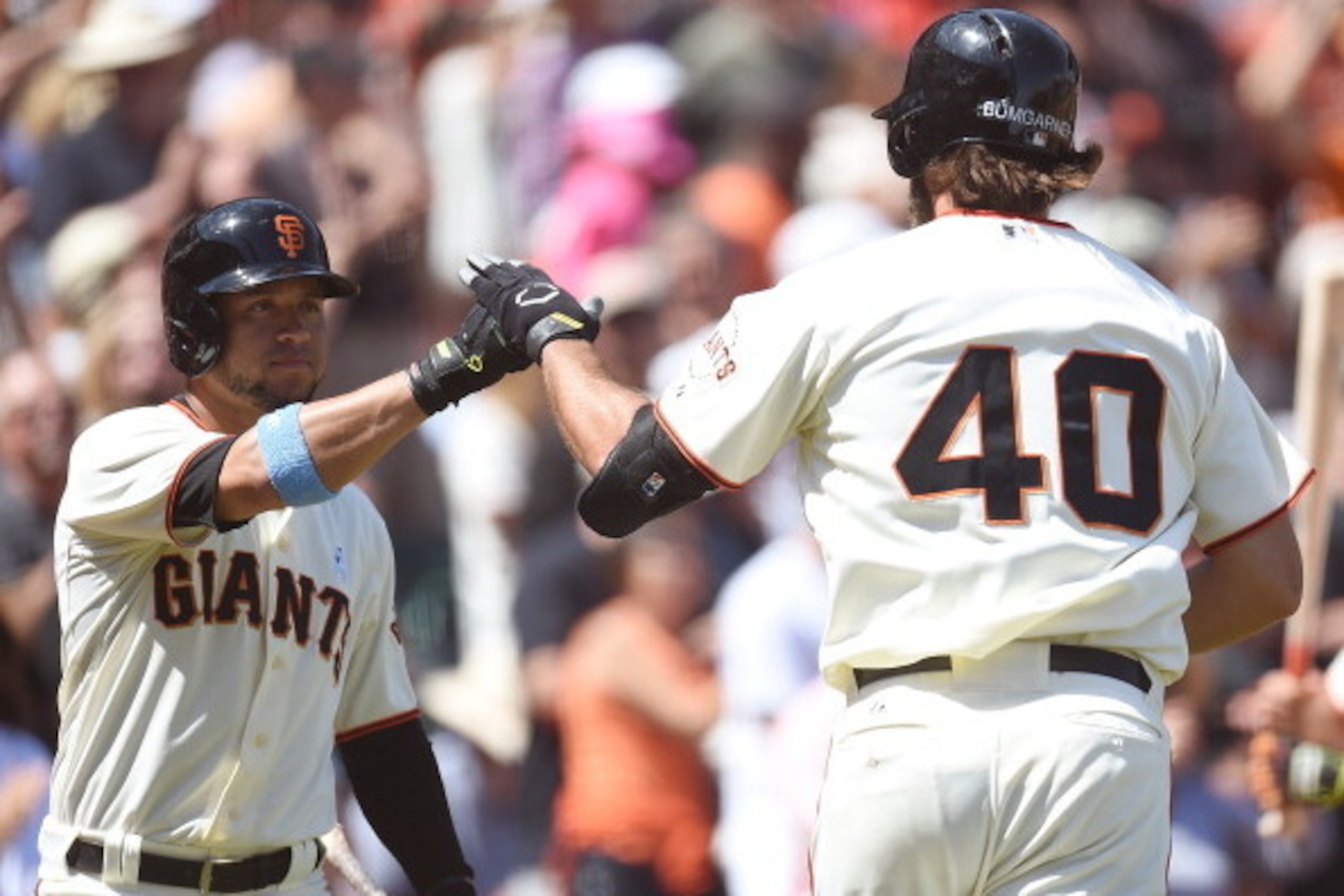 SAN FRANCISCO, CA - JUNE 15: Pitcher Madison Bumgarner #40 of the San Francisco Giants is congratulated by Gregor Blanco #7 after Bumgarner hit a solo home run in the bottom of the fifth inning against the Colorado Rockies at AT&T Park on June 15, 2014 i SAN FRANCISCO, CA - JUNE 15: Pitcher Madison Bumgarner #40 of the San Francisco Giants is congratulated by Gregor Blanco #7 after Bumgarner hit a solo home run in the bottom of the fifth inning against the Colorado Rockies at AT&T Park on June 15, 2014 i