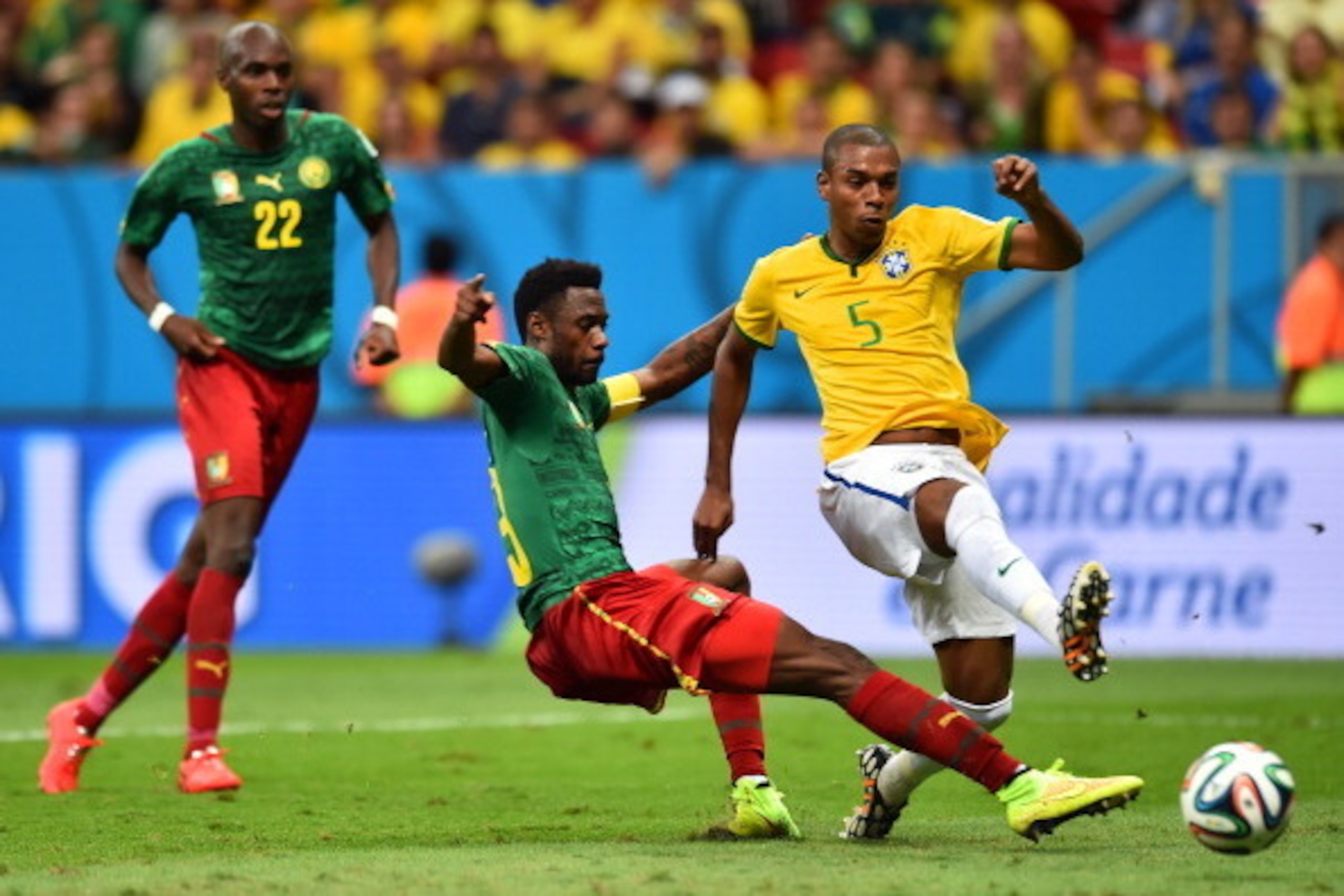 BRASILIA, BRAZIL - JUNE 23: Fernandinho of Brazil scores his team's fourth goal against Nicolas N'Koulou of Cameroon during the 2014 FIFA World Cup Brazil Group A match between Cameroon and Brazil at Estadio Nacional on June 23, 2014 in Brasilia, Brazil. 
