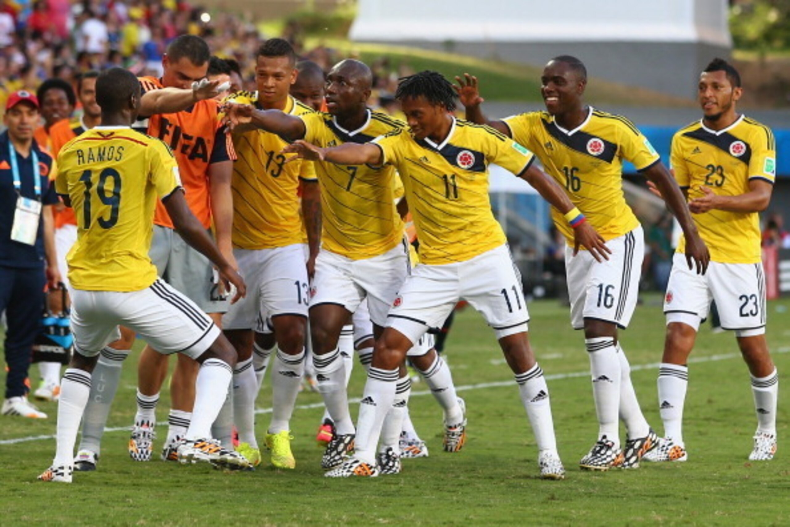 CUIABA, BRAZIL - JUNE 24: Juan Guillermo Cuadrado of Colombia celebrates with teammates scoring his team's first goal after a penalty kick during the 2014 FIFA World Cup Brazil Group C match between Japan and Colombia at Arena Pantanal on June 24, 2014 i CUIABA, BRAZIL - JUNE 24: Juan Guillermo Cuadrado of Colombia celebrates with teammates scoring his team's first goal after a penalty kick during the 2014 FIFA World Cup Brazil Group C match between Japan and Colombia at Arena Pantanal on June 24, 2014 i