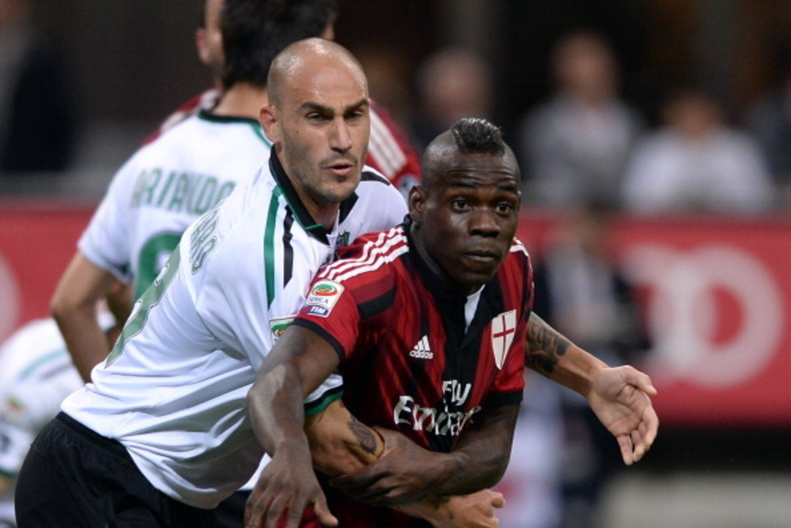 MILAN, ITALY - MAY 18:  Mario Balotelli of AC Milan and Paolo Cannavaro of US Sassuolo Calcio (L) during the Serie A match between AC Milan and US Sassuolo Calcio at San Siro Stadium on May 18, 2014 in Milan, Italy.  (Photo by Claudio Villa/Getty Images)