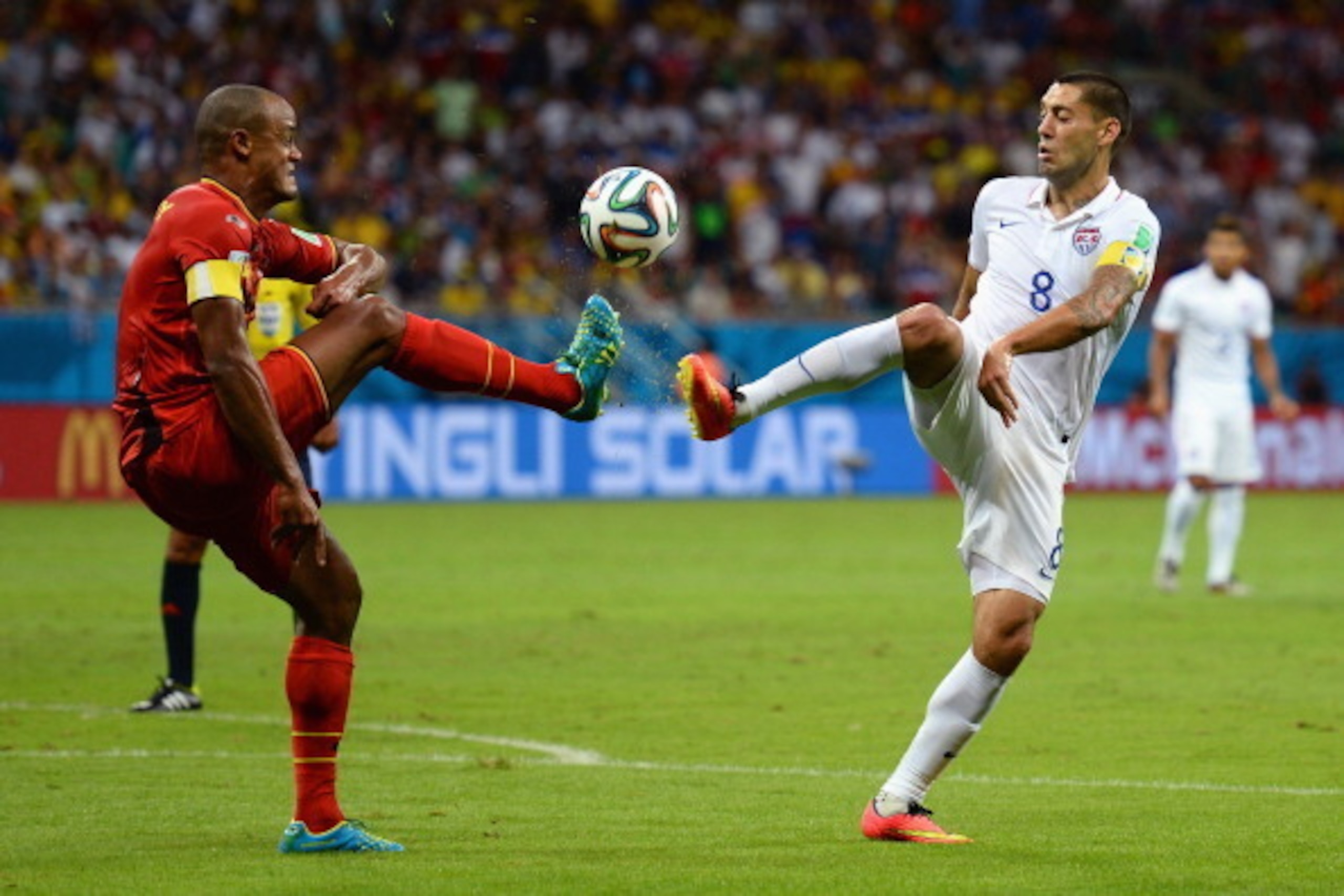 SALVADOR, BRAZIL - JULY 01: Vincent Kompany of Belgium and Clint Dempsey of the United States compete for the ball during the 2014 FIFA World Cup Brazil Round of 16 match between Belgium and the United States at Arena Fonte Nova on July 1, 2014 in Salvado