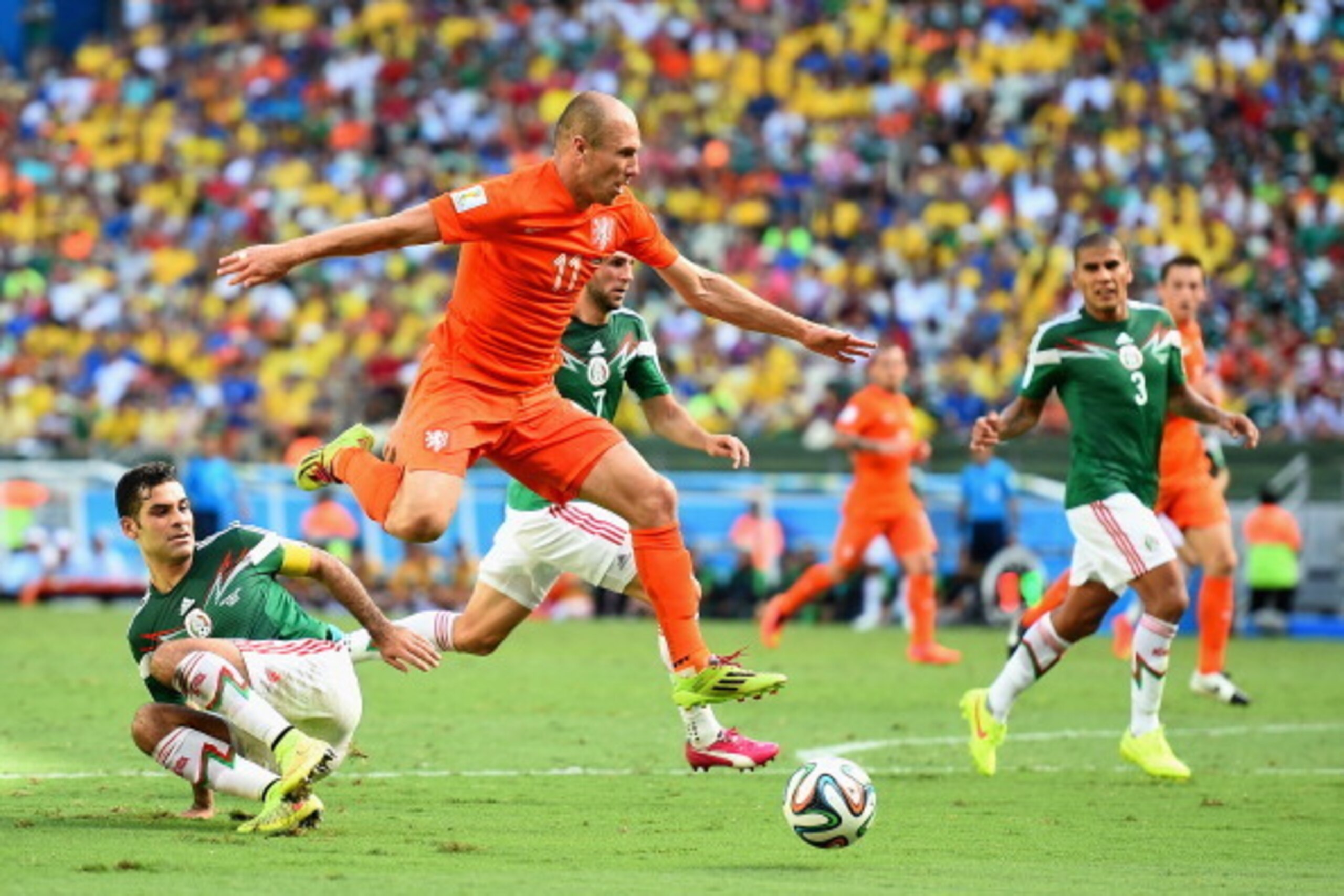 FORTALEZA, BRAZIL - JUNE 29: Arjen Robben of the Netherlands rides the tackle of Rafael Marquez of Mexico during the 2014 FIFA World Cup Brazil Round of 16 match between Netherlands and Mexico at Castelao on June 29, 2014 in Fortaleza, Brazil.  (Photo by 