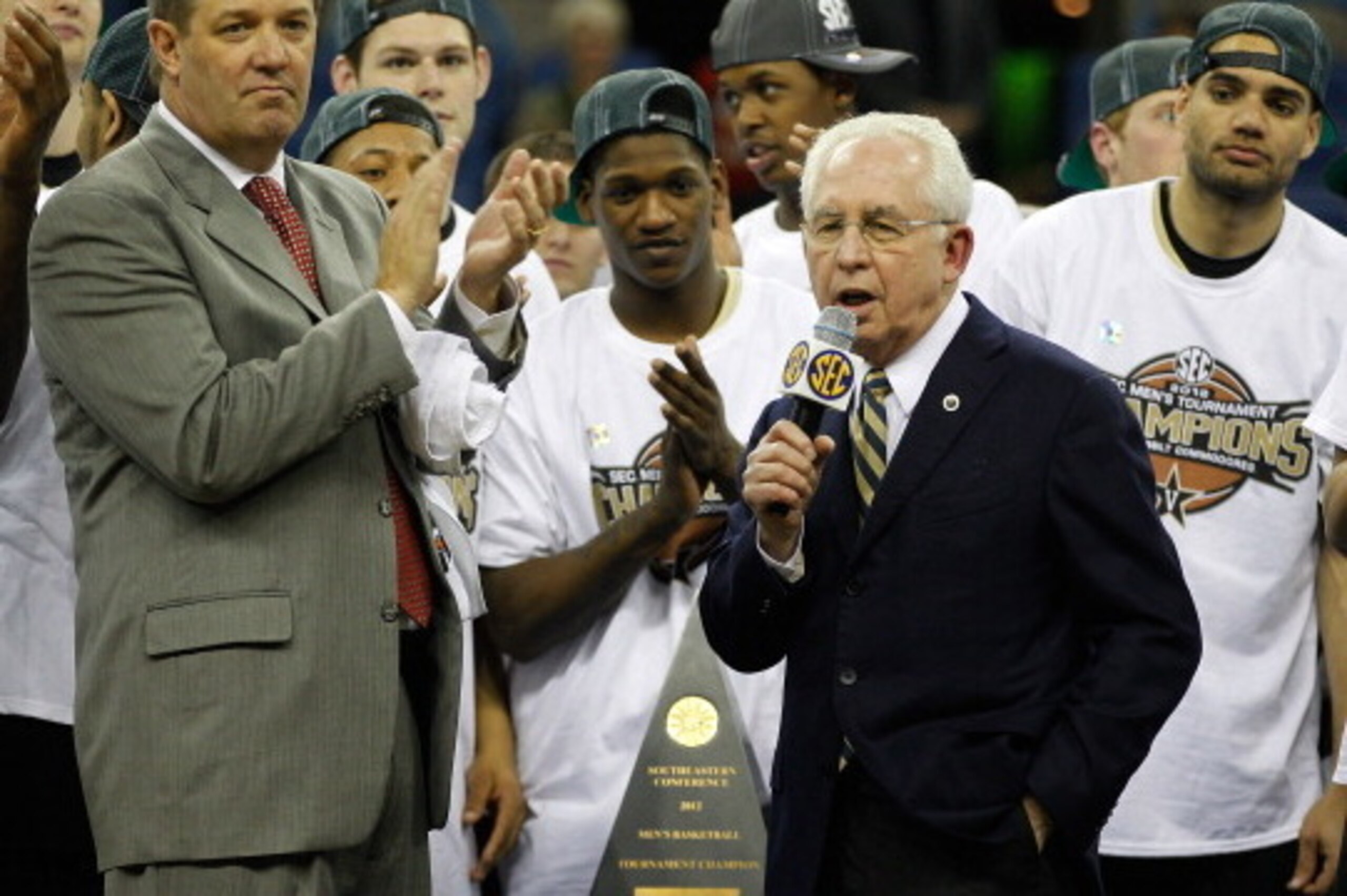 NEW ORLEANS, LA - MARCH 11:  Southeastern Conference commissioner Mike Slive presents head coach Kevin Stallings of the Vanderbilt Commodores with the trophy after their 71 to 64 win over the Kentucky Wildcats in the championship game of the 2012 SEC Men'