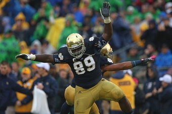 SOUTH BEND, IN - OCTOBER 13: Kapron Lewis-Moore #89 and Matthias Farley #41 of the Notre Dame Fighting Irish celebrate a blocking field goal against the Standford Cardinal at Notre Dame Stadium on October 13, 2012 in South Bend, Indiana. Notre Dame defeat