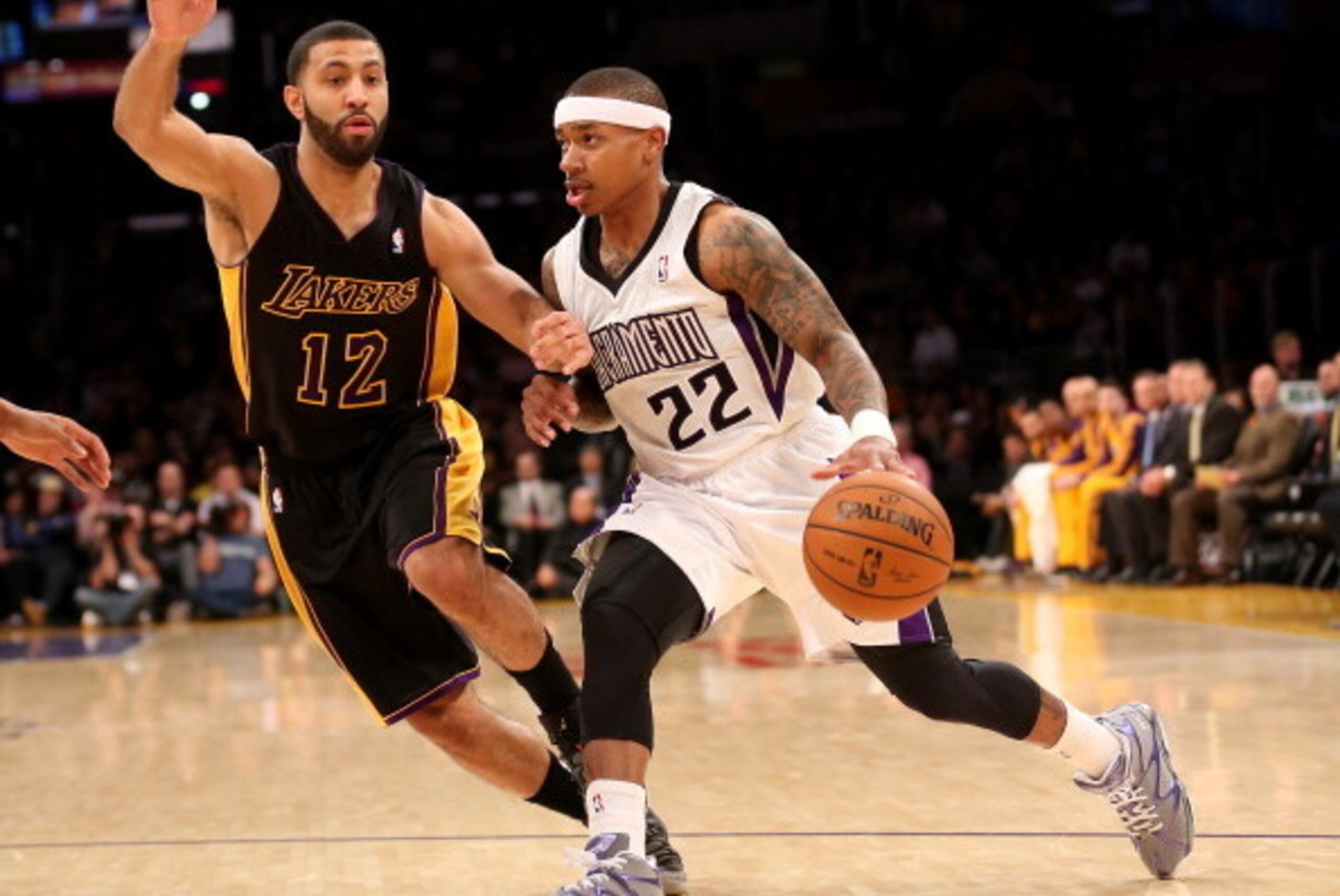 LOS ANGELES, CA - FEBRUARY 28:  Isaiah Thomas #22 of the Sacramento Kings drives past Kendall Marshall #12 of the Los Angeles Lakers at Staples Center on February 28, 2014 in Los Angeles, California.  NOTE TO USER: User expressly acknowledges and agrees t