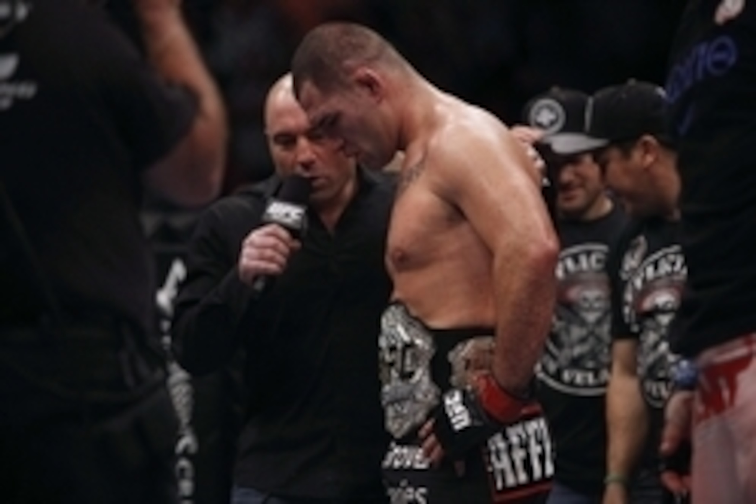 Oct 19, 2013; Houston, TX, USA; Cain Velasquez (red gloves) is interviewed by commentator Joe Rogan following the world heavyweight championship bout during UFC 166 at Toyota Center. Mandatory Credit: Andrew Richardson-USA TODAY Sports
