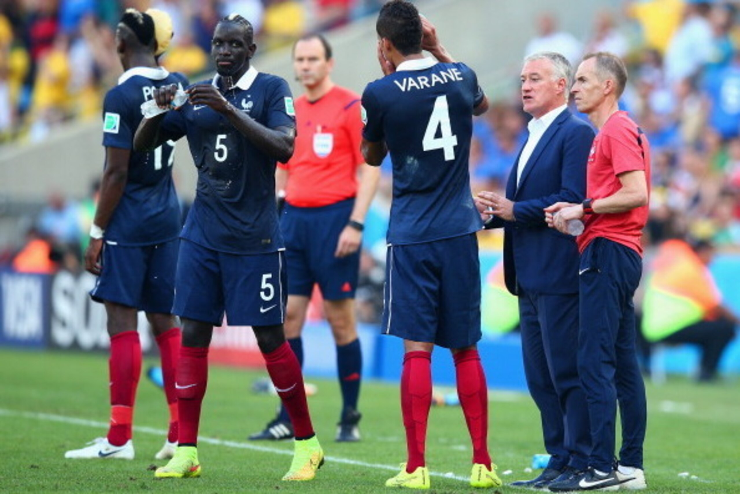RIO DE JANEIRO, BRAZIL - JULY 04: Head coach Didier Deschamps of France (2nd R) speaks to players on the sideline during the 2014 FIFA World Cup Brazil Quarter Final match between France and Germany at Maracana on July 4, 2014 in Rio de Janeiro, Brazil.