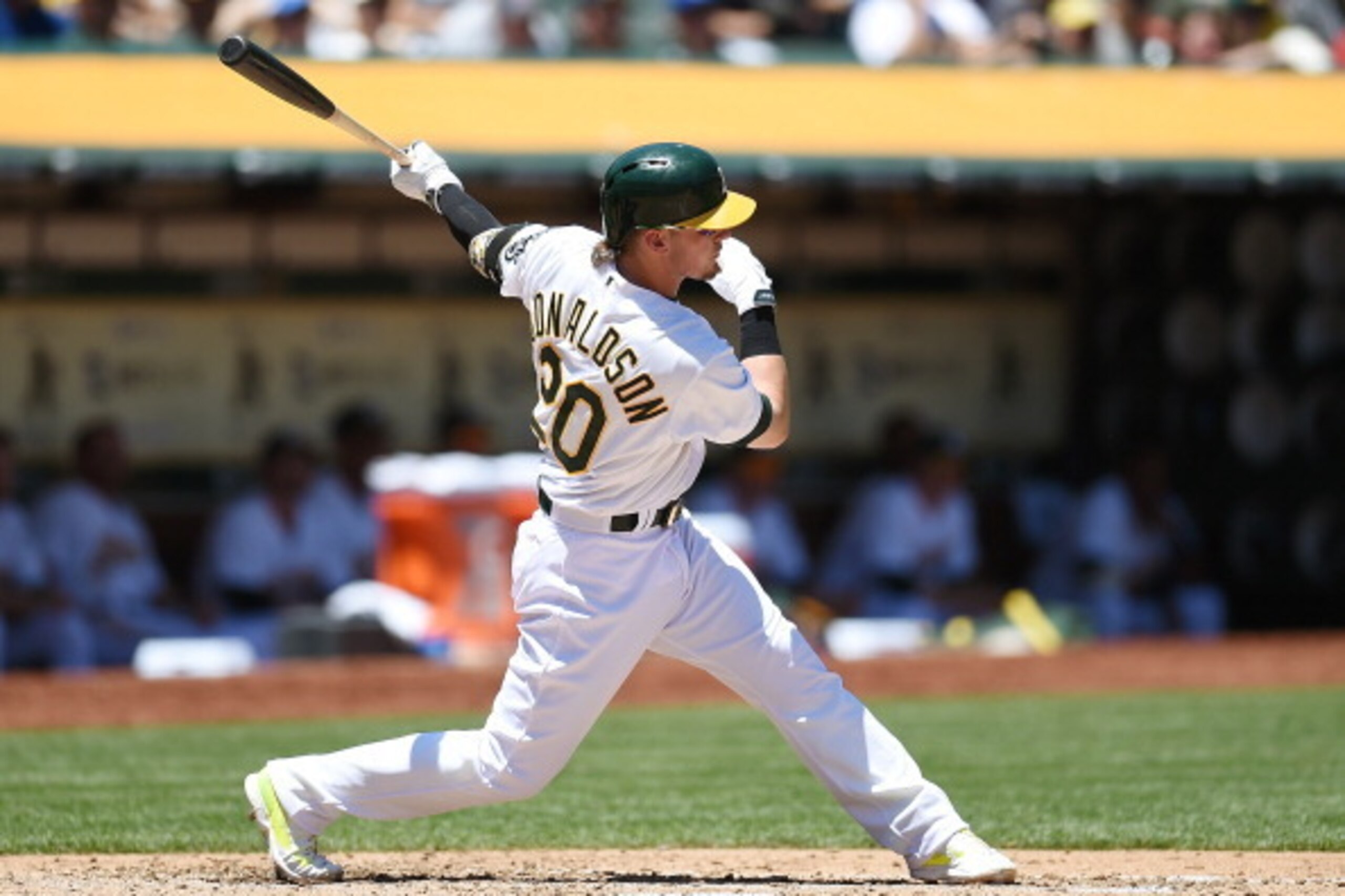 OAKLAND, CA - JUNE 18:  Josh Donaldson #20 of the Oakland Athletics hits an RBI single scoring John Jaso #5 in the bottom of the third inning against the Texas Rangers at O.co Coliseum on June 18, 2014 in Oakland, California.  (Photo by Thearon W. Henders