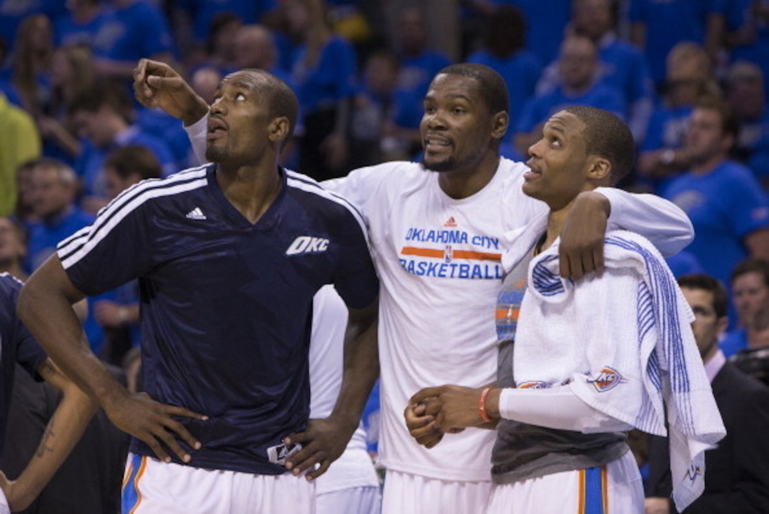OKLAHOMA CITY, OK - APRIL 19:  Serge Ibaka #9, Kevin Durant #35 and Russell Westbrook #0 of the Oklahoma City Thunder talk during the Memphis Grizzlies in Game One of the Western Conference Quarterfinals of the NBA Playoffs at Chesapeake Energy Arena on A
