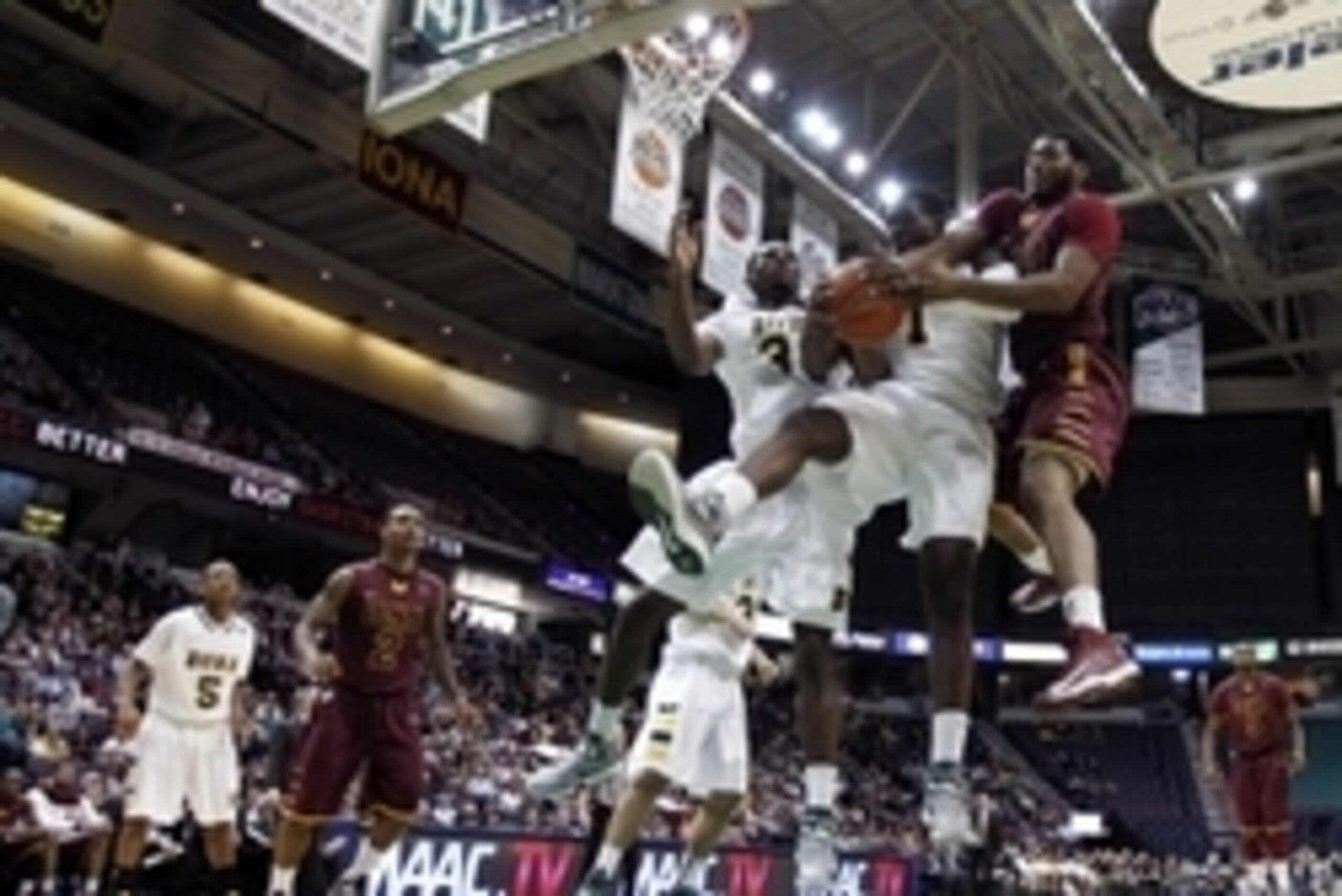 Jan 4, 2013; Albany, NY, USA; Iona Gaels forward David Laury (13) and Siena Saints forward O.D. Anosike (1) battle for a rebound during the second half at Times Union Center.  Mandatory Credit: Mark L. Baer-USA TODAY Sports