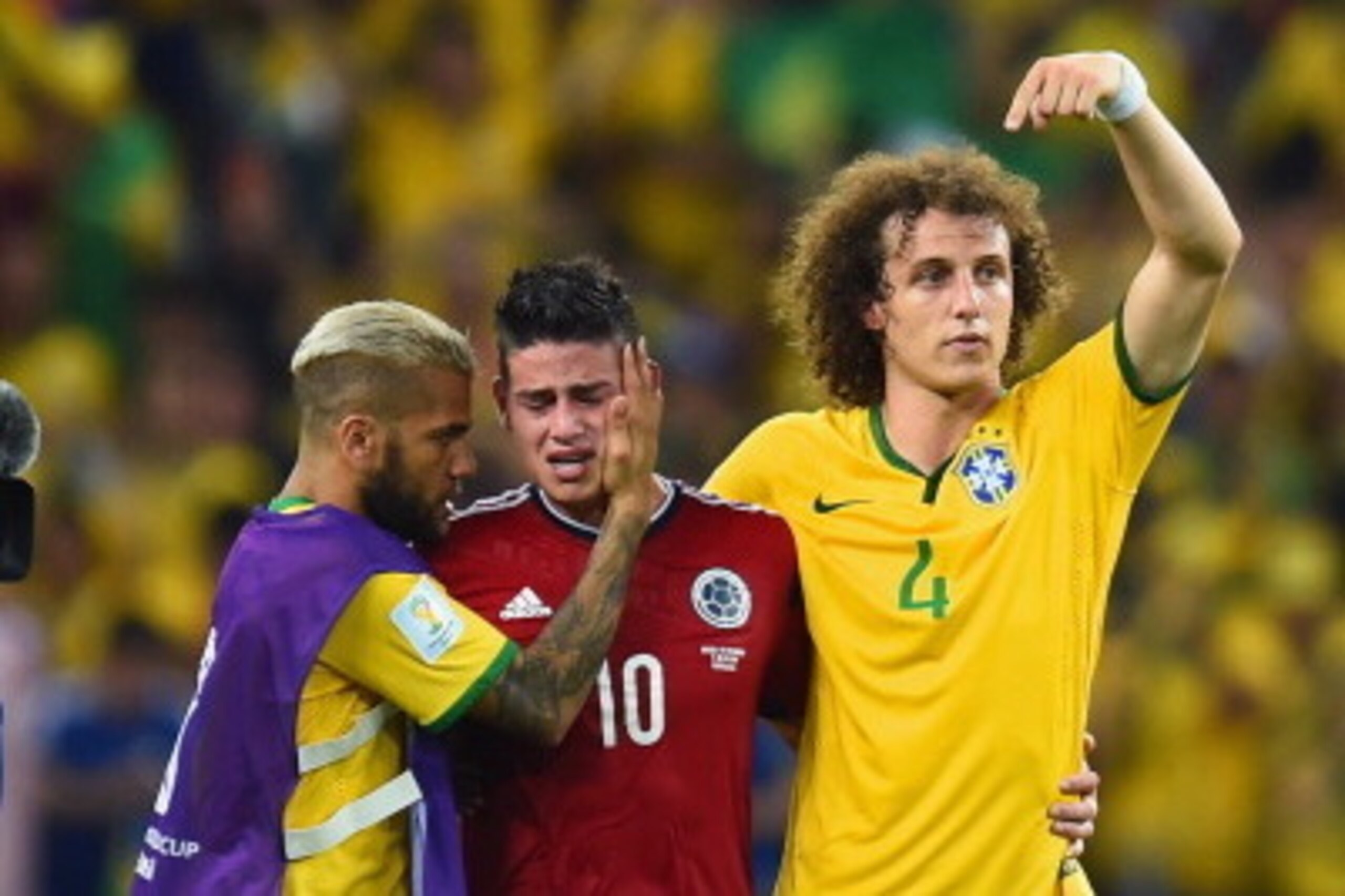 FORTALEZA, BRAZIL - JULY 04:  Dani Alves (L) and David Luiz of Brazil console James Rodriguez of Colombia after Brazil's 2-1 win during the 2014 FIFA World Cup Brazil Quarter Final match between Brazil and Colombia at Castelao on July 4, 2014 in Fortaleza
