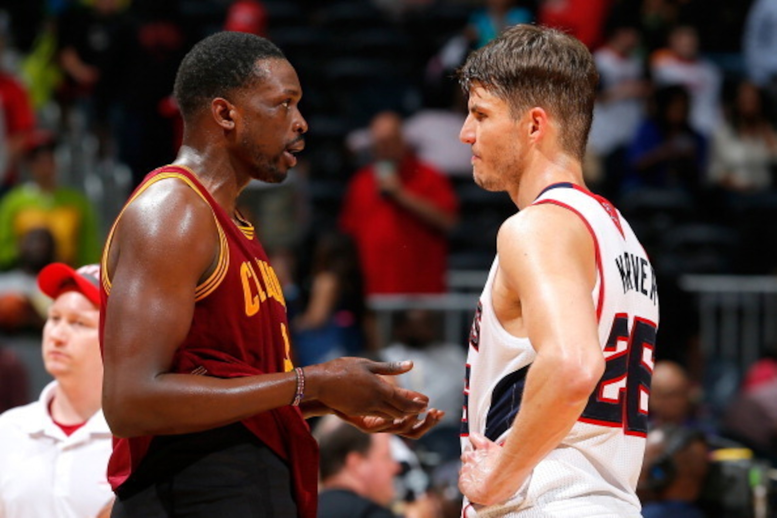 ATLANTA, GA - APRIL 04:  Luol Deng #9 of the Cleveland Cavaliers converses with Kyle Korver #26 of the Atlanta Hawks after their 117-98 loss at Philips Arena on April 4, 2014 in Atlanta, Georgia.  NOTE TO USER: User expressly acknowledges and agrees that,
