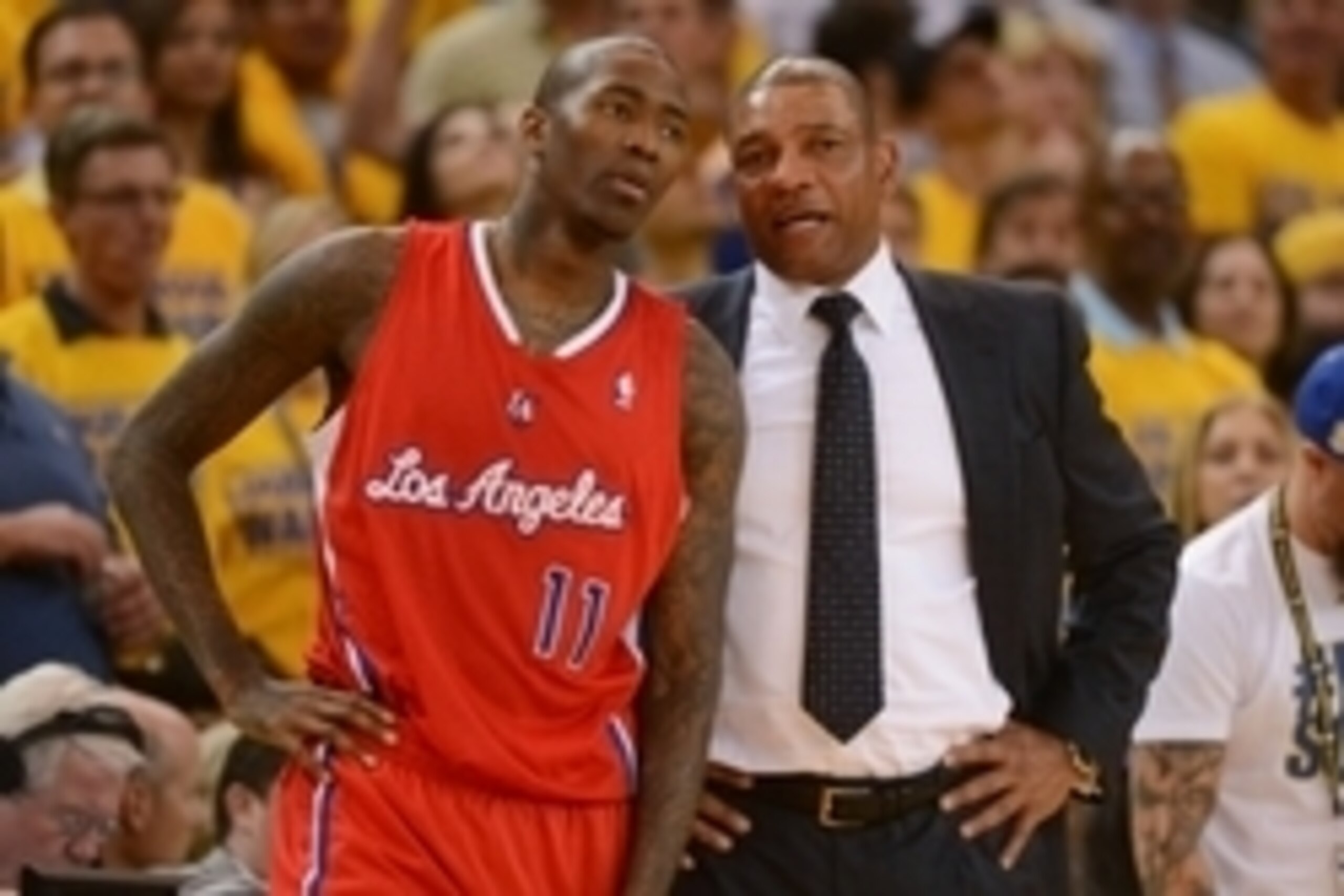 May 1, 2014; Oakland, CA, USA; Los Angeles Clippers guard Jamal Crawford (11) talks to head coach Doc Rivers (right) during the third quarter in game six of the first round of the 2014 NBA Playoffs against the Golden State Warriors at Oracle Arena. The Wa