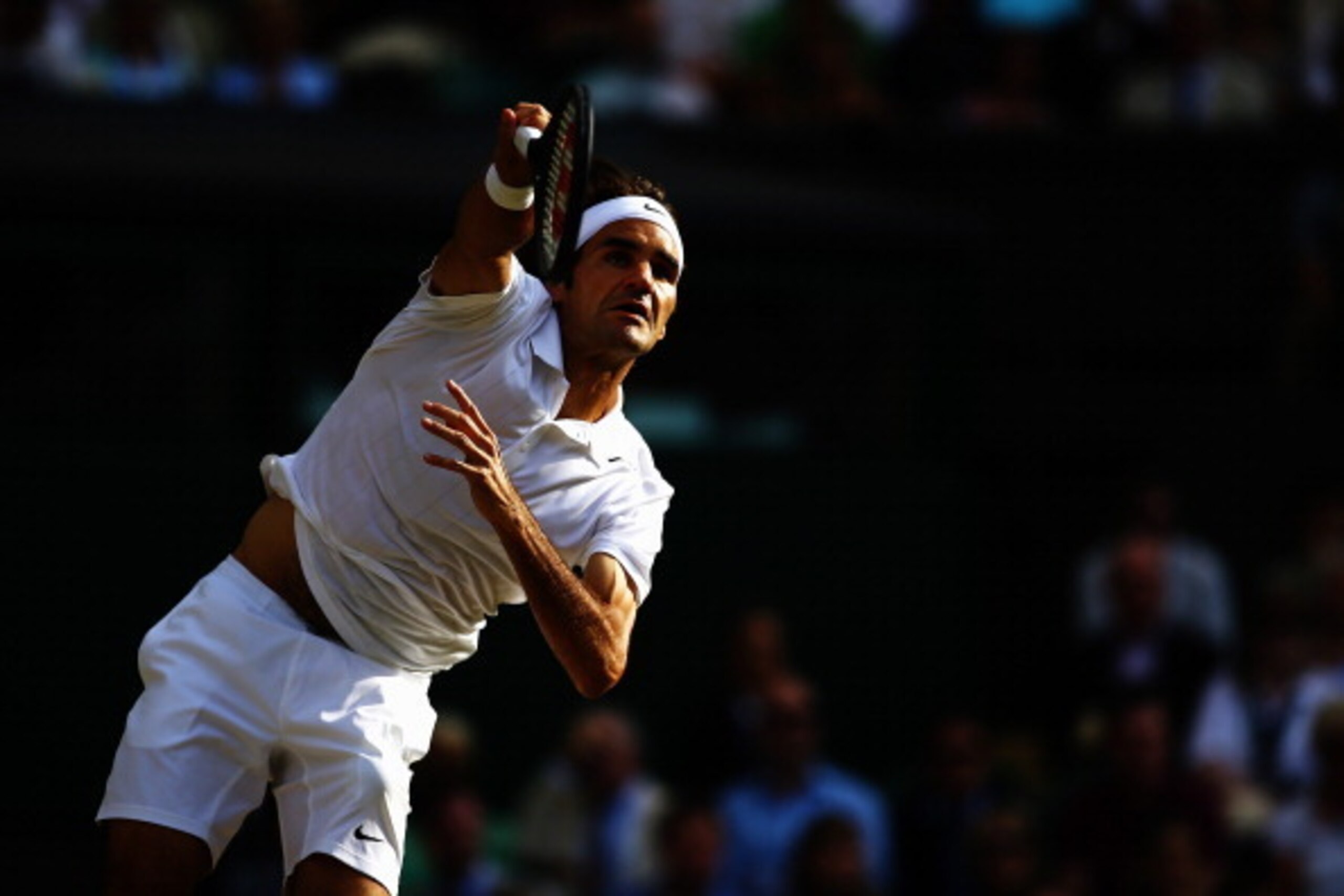 LONDON, ENGLAND - JULY 04:  Roger Federer of Switzerland serves during the Gentlemen's Singles semi-final against Milos Raonic of Canada on day eleven of the Wimbledon Lawn Tennis Championships at the All England Lawn Tennis and Croquet Club on July 4, 20