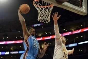 Mar 9, 2014; Los Angeles, CA, USA; Oklahoma City Thunder center Hasheem Thabeet (34) shoots over Los Angeles Lakers center Pau Gasol (16) during the first half at Staples Center. Mandatory Credit: Richard Mackson-USA TODAY Sports