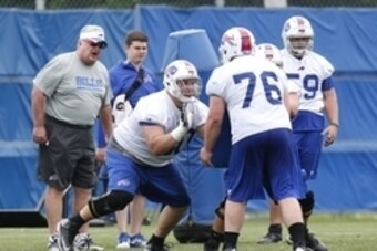 Jun 18, 2014; Buffalo, NY, USA; Buffalo Bills offensive lineman Kraig Urbik (60) performs a drill against center Macky MacPherson (76) during the Bills Minicamp at Ralph Wilson Stadium. Mandatory Credit: Kevin Hoffman-USA TODAY Sports