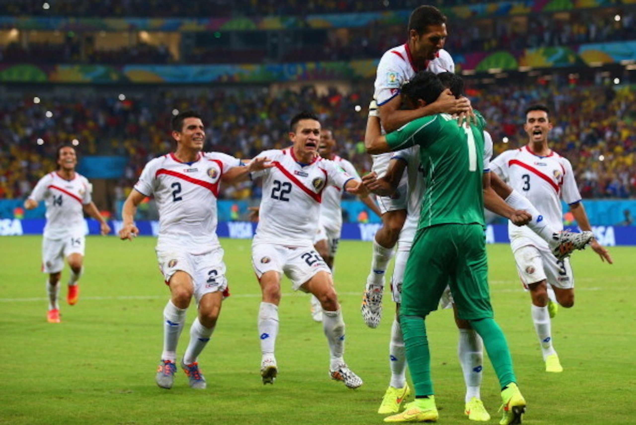 RECIFE, BRAZIL - JUNE 29: Keylor Navas of Costa Rica is swarmed by teammates in celebration after defeating Greece in a penalty shootout during the 2014 FIFA World Cup Brazil Round of 16 match between Costa Rica and Greece at Arena Pernambuco on June 29, 
