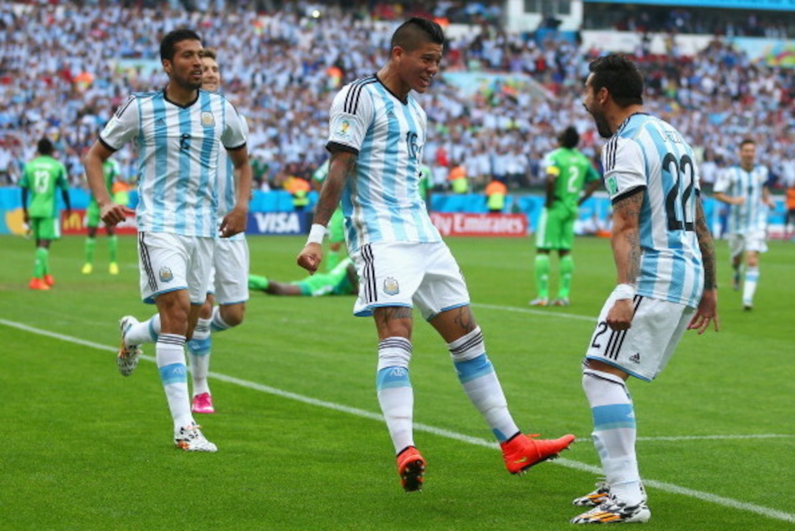 PORTO ALEGRE, BRAZIL - JUNE 25:  Marcos Rojo of Argentina (C) celebrates scoring his team's third goal with Ezequiel Garay (L) and Ezequiel Lavezzi during the 2014 FIFA World Cup Brazil Group F match between Nigeria and Argentina at Estadio Beira-Rio on J