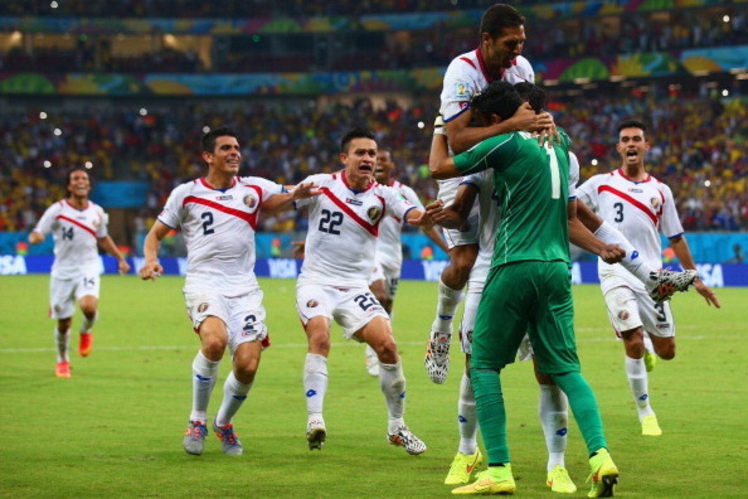 RECIFE, BRAZIL - JUNE 29: Keylor Navas of Costa Rica is swarmed by teammates in celebration after defeating Greece in a penalty shootout during the 2014 FIFA World Cup Brazil Round of 16 match between Costa Rica and Greece at Arena Pernambuco on June 29, 