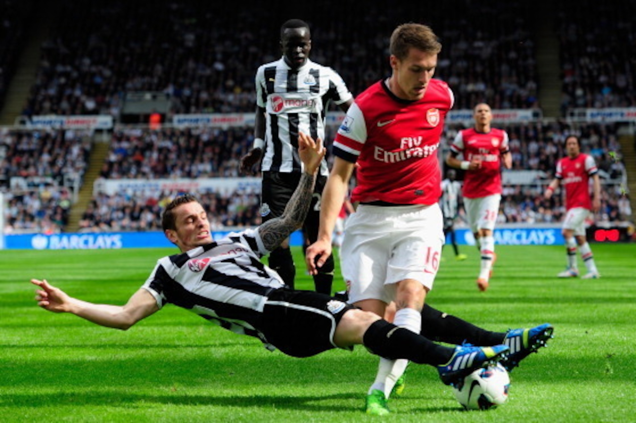 NEWCASTLE UPON TYNE, ENGLAND - MAY 19:  Arsenal player Aaron Ramsey (r) is tackled by Mathieu Debuchy of Newcastle during the Barclays Premier League match between Newcastle United and Arsenal at St James' Park on May 19, 2013 in Newcastle upon Tyne, Engl